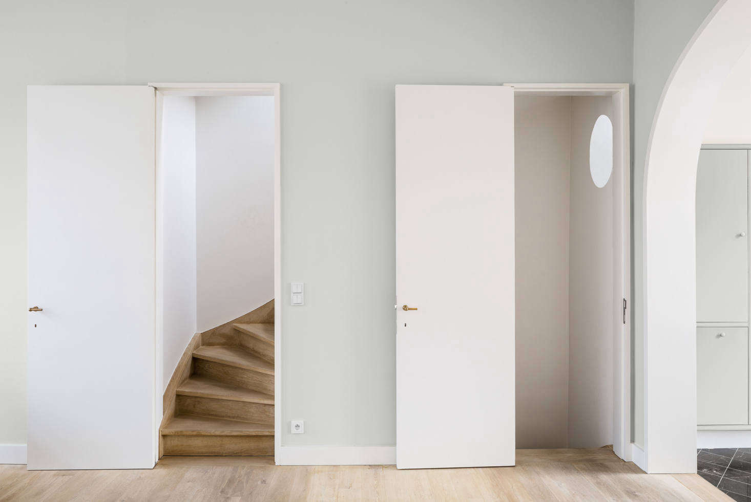 The stairways, tucked behind the wall.