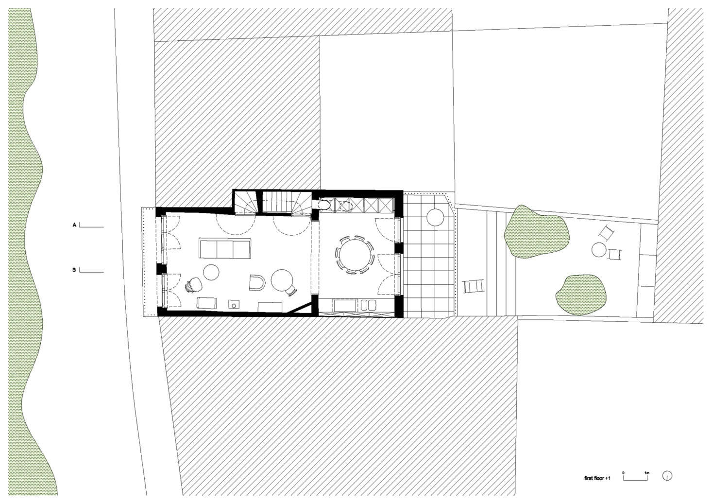 The next floor up, showing the living area and kitchen, with the staircase and cabinetry set into the walls. This floor also opens onto the balcony (on the street side) and a sunny terrace (in back). There is a top floor, which the architects say is fitted with “guest amenities.”
