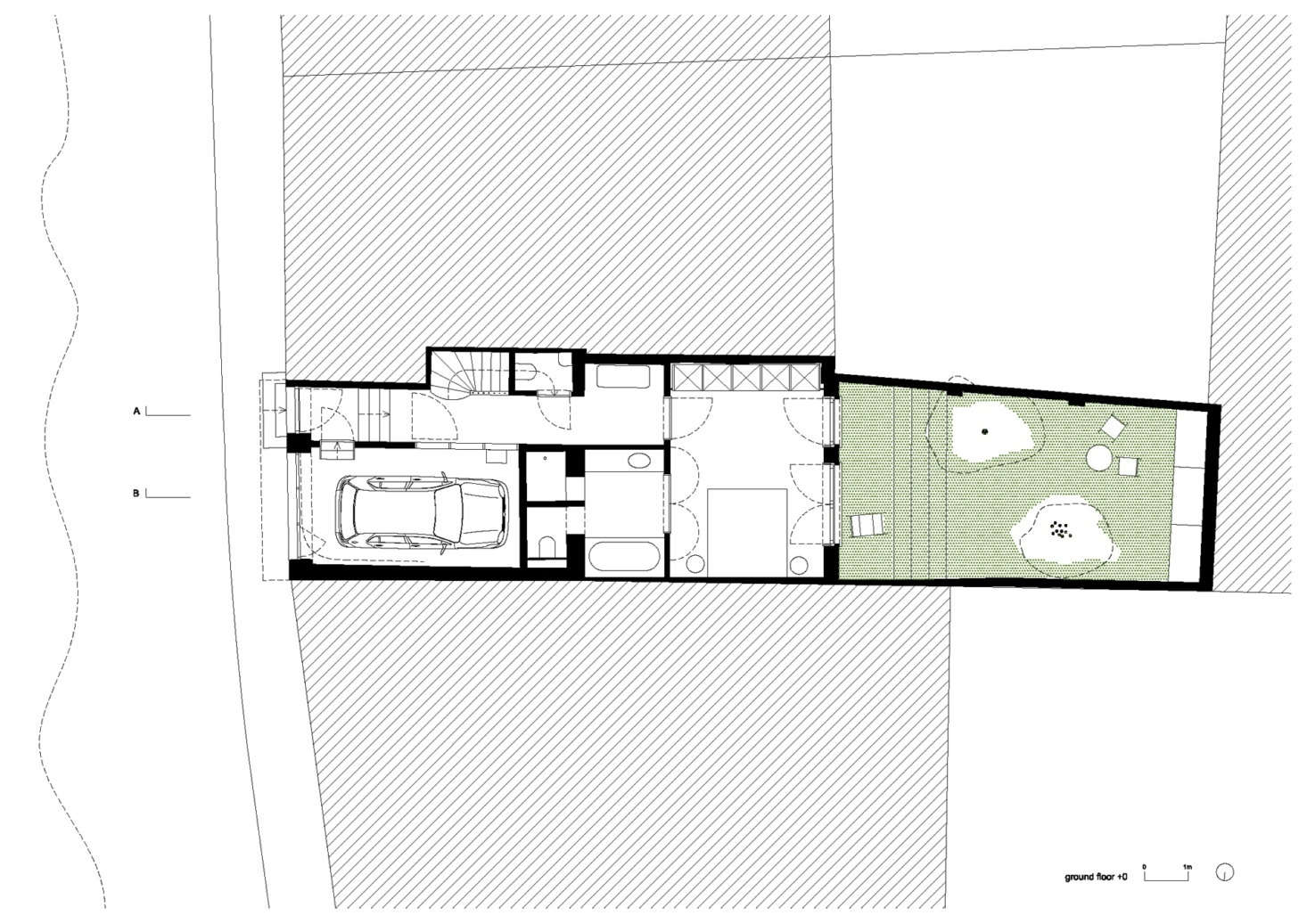 The ground floor of the townhouse, with a garage in front that sets the private areas—the master bedroom and bathroom—back from the street. Behind the bedroom is a “silent” patio,” the architects say.