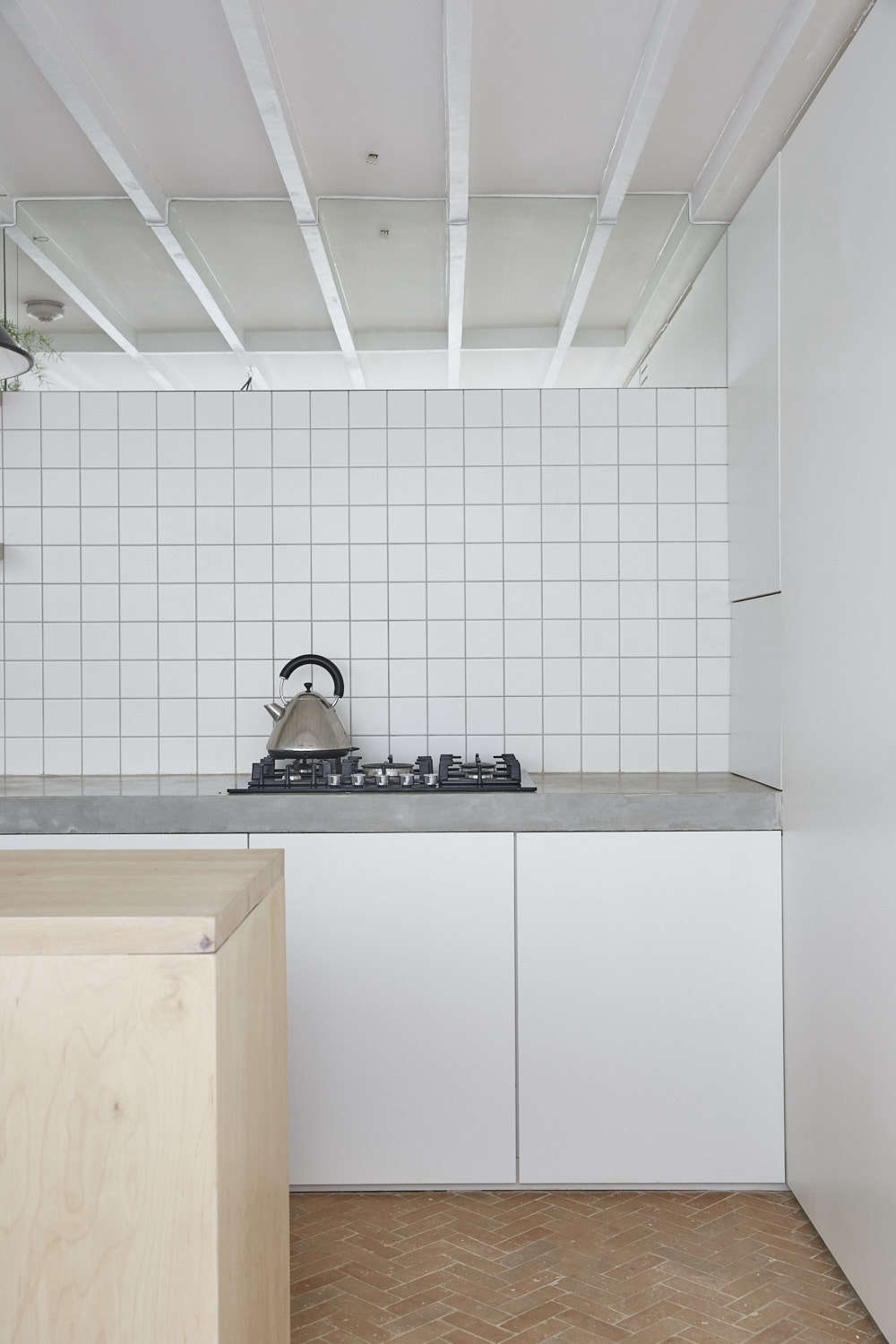 To the right of the range, more hidden storage, plus a concealed fridge, freezer, microwave, and washing machine.