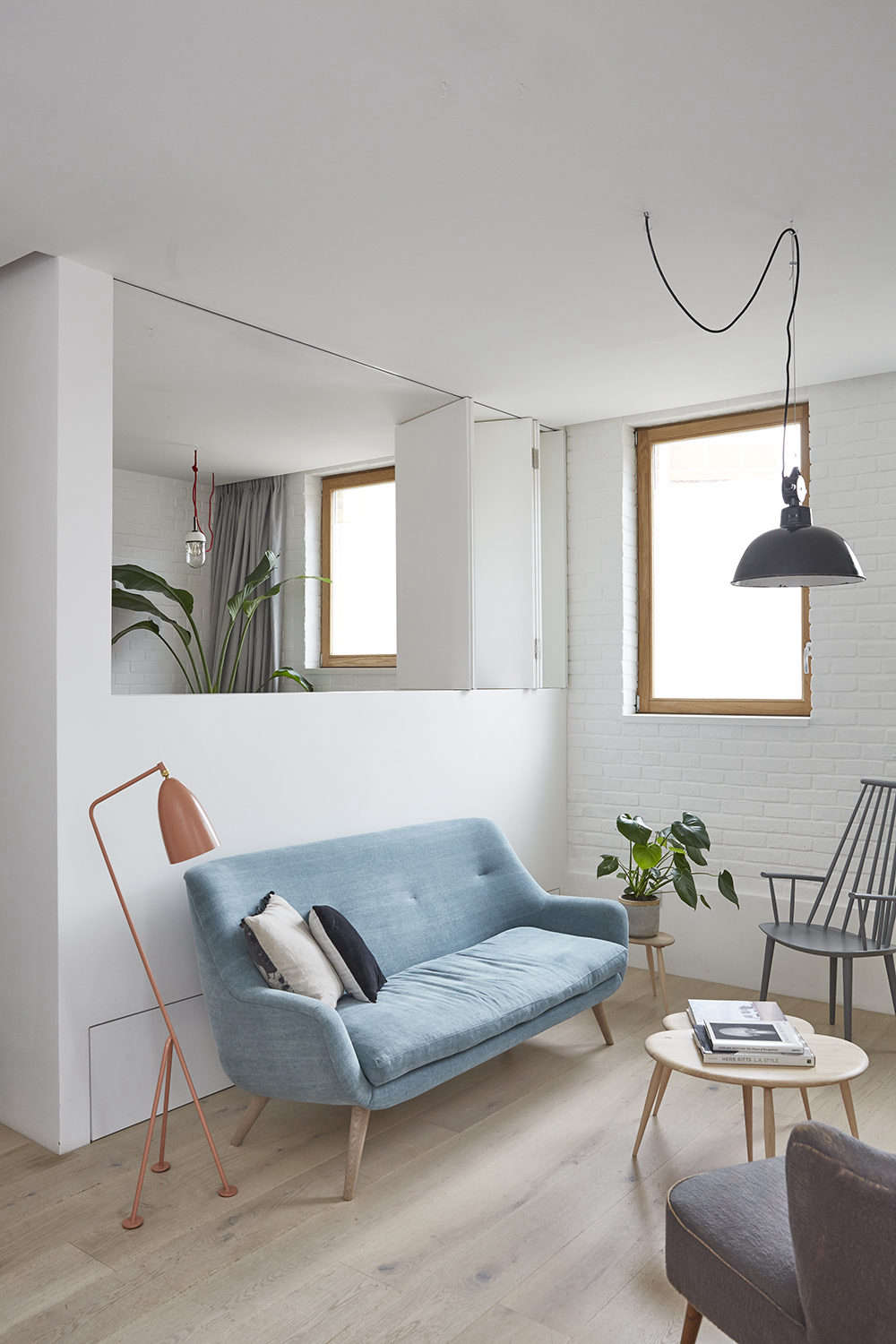 Hutchinson started by re-jiggering the interiors of the small house: knocking down almost all of the interior walls in favor of half-walls, so that light could pass through. 