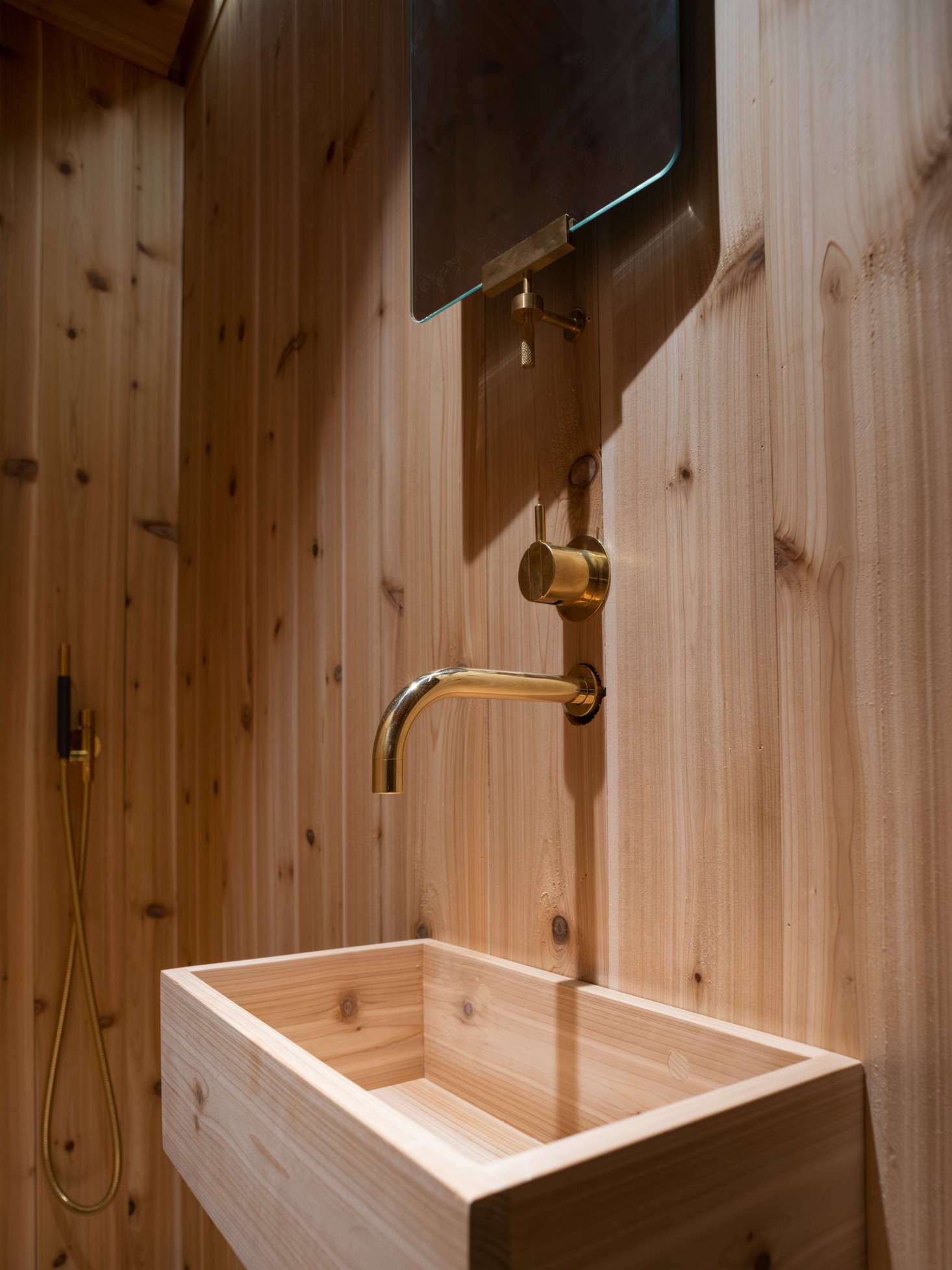 The brass fixtures are by Vola and the brass-framed mirror is the KBH Mirror.