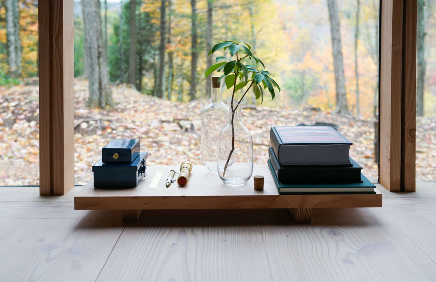 A low wooden table echoes the design of the bed frame.