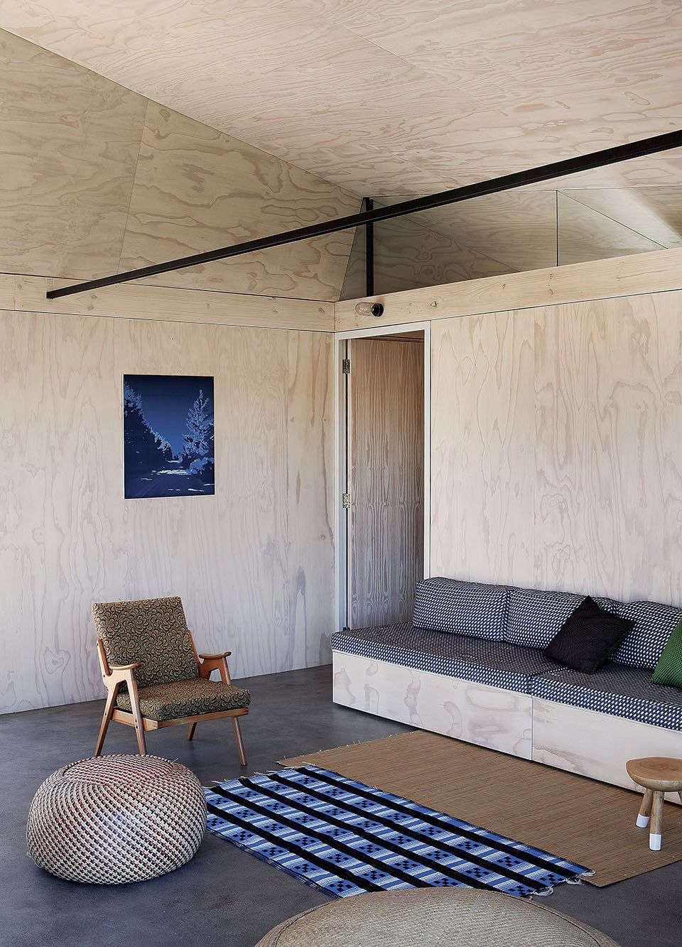 The owners’ midcentury lounge chair is upholstered with Shweshwe, a traditional South African print.