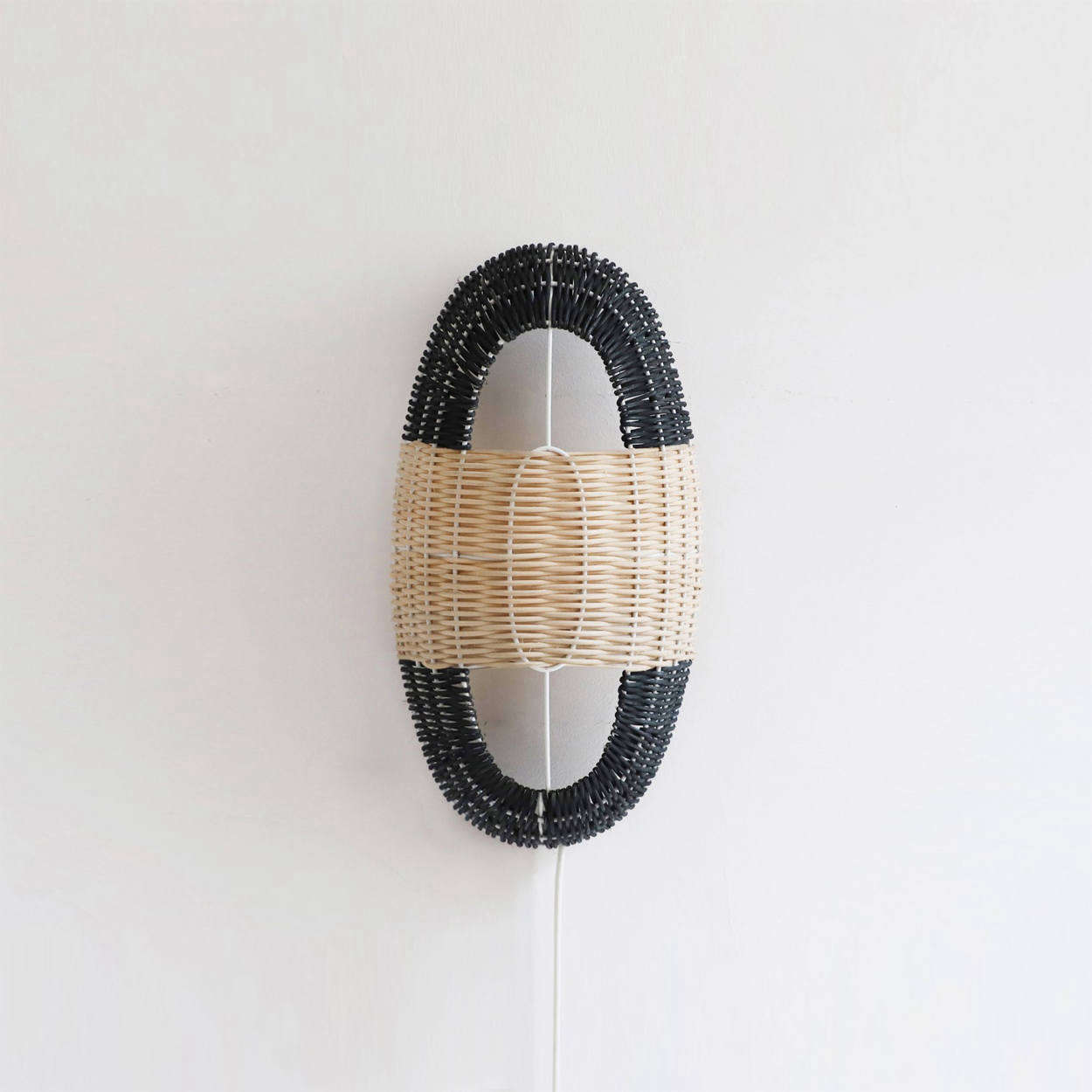 The Arc Small Lamp in Black and Natural Rattan is €235.