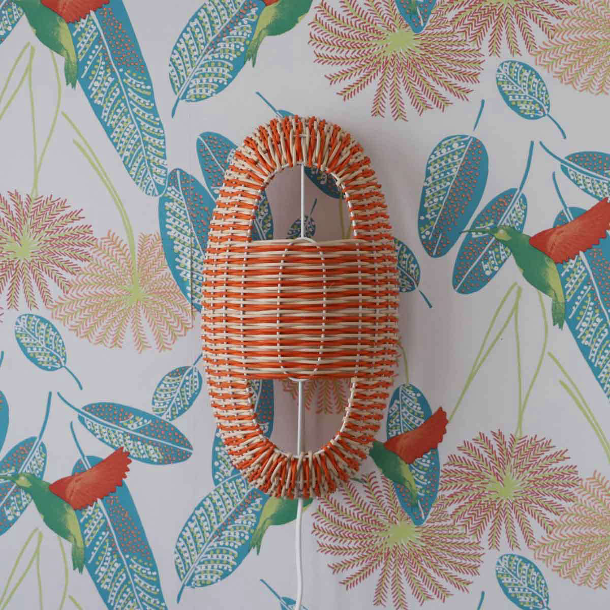 The Arc Small Lamp in Coral and Natural Rattan on a white lacquered frame is €235.