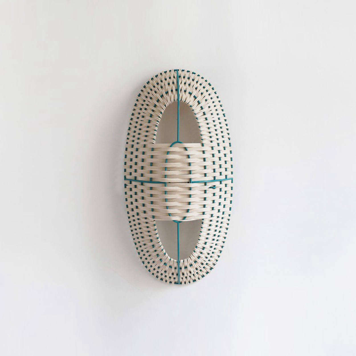 The Arc Medium Lamp in Natural Rattan on a green lacquered frame is €295.