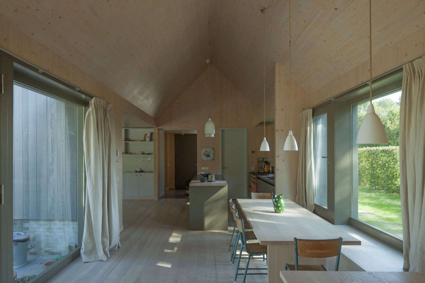 Cerulean school chairs—vintage, sourced by the homeowners—in An Agrarian-Inspired Holiday House on an Agricultural Dutch Island.