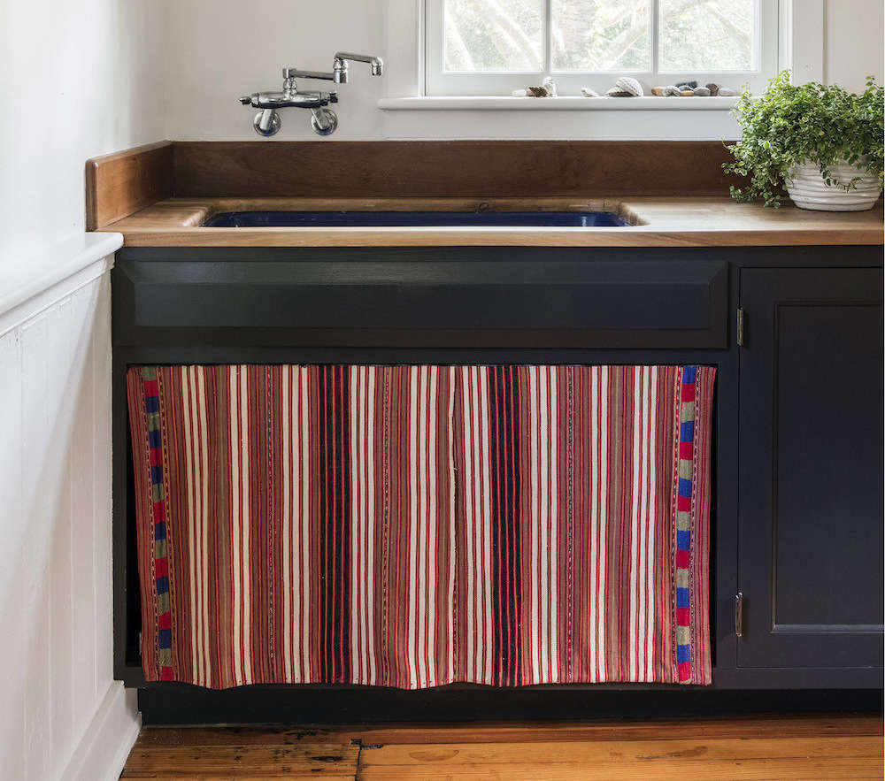 In her Bellport, NY, summer house, architect Elizabeth Roberts had a sink skirt sewn from a vintage Guatemalan textile in lieu of cabinet doors (see Elizabeth Roberts at Home: The Architect’s Own Beach House). For more ideas, go to New Old Trend: 10 Fresh Examples of Sink Skirts and Cabinet Curtains on The Organized Home.