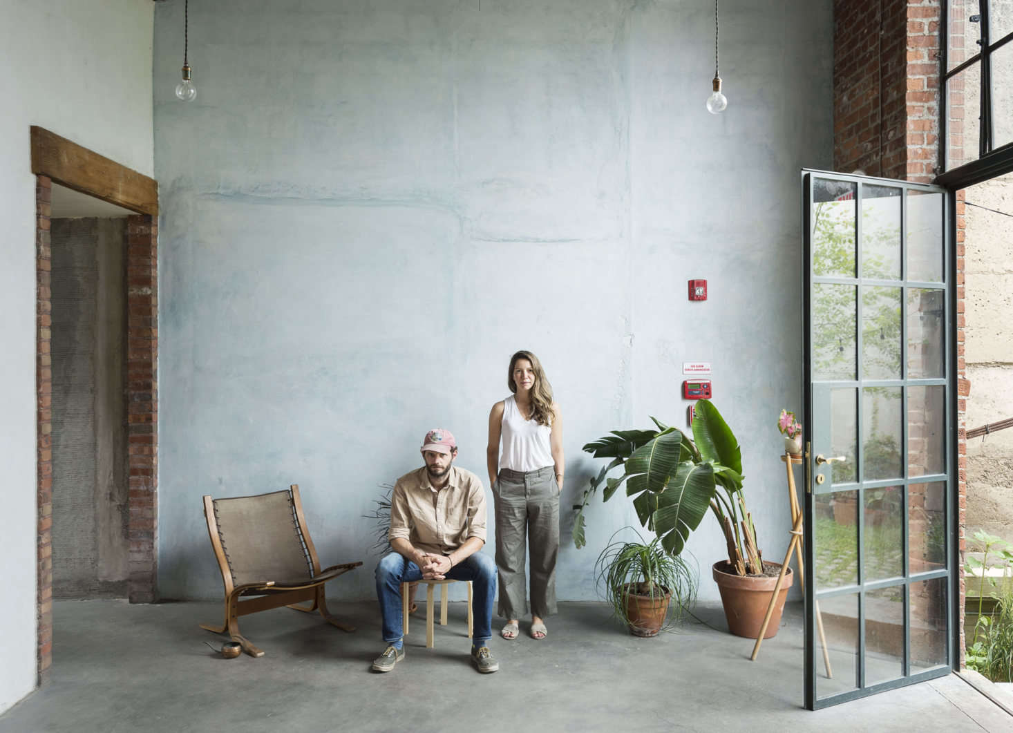 Thom and Bretaigne both studied architecture at City College and met their partner Eli (who is absent from the photo) through the NYC architecture scene; together, the three formed Fabr in 2012. The team created the luminous accent wall using Rainbow Cement pigment; “it was a trial-by-error process,” Bretaigne says. The chair is the midcentury Siesta lounge chair by Ingmar Relling, which they found on the street (similar chairs go for about $2,000 on 1st Dibs).