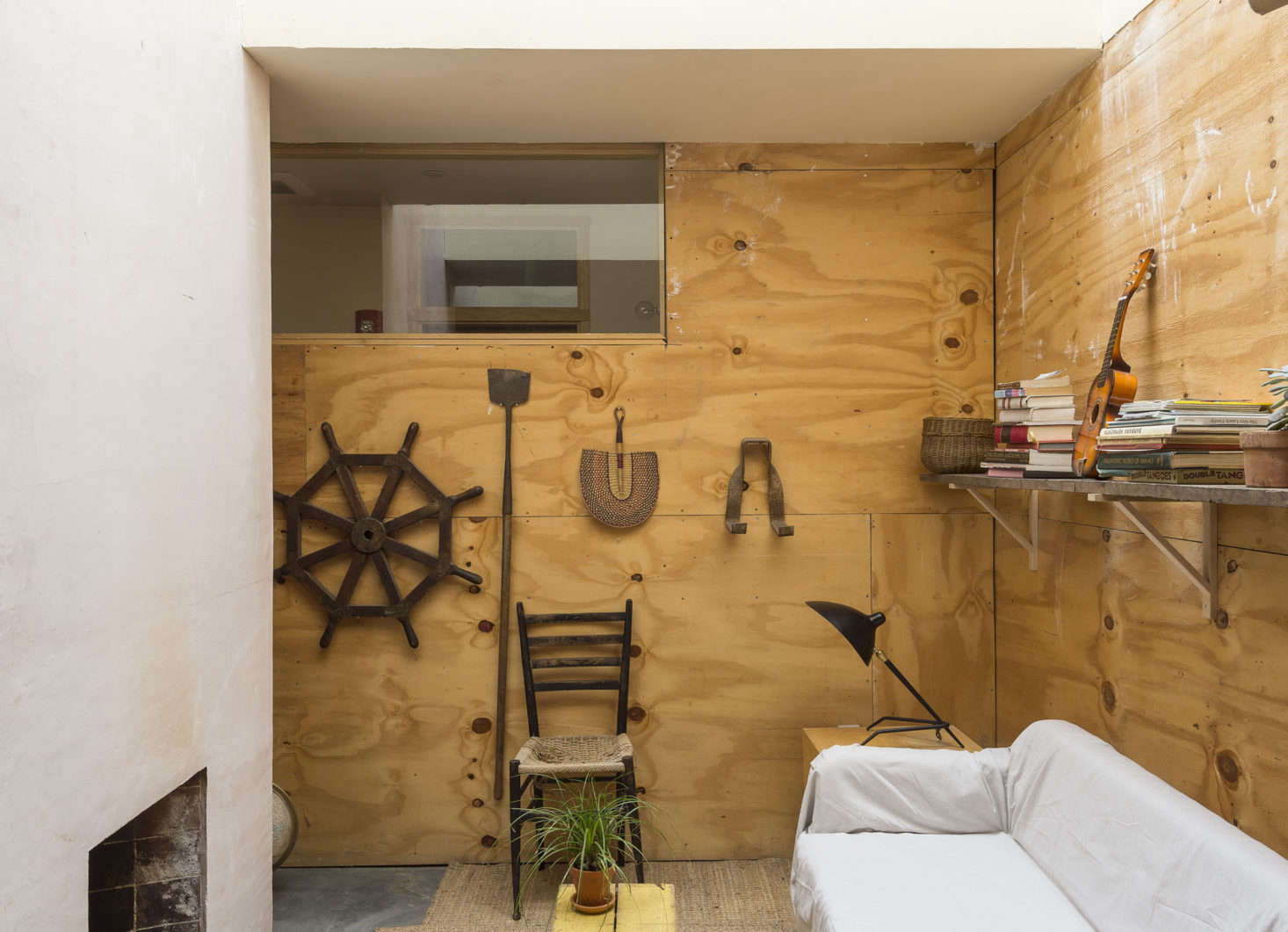 A small alcove off the office space serves as a retreat from the office; the Ikea couch is draped in a simple canvas drop cloth.