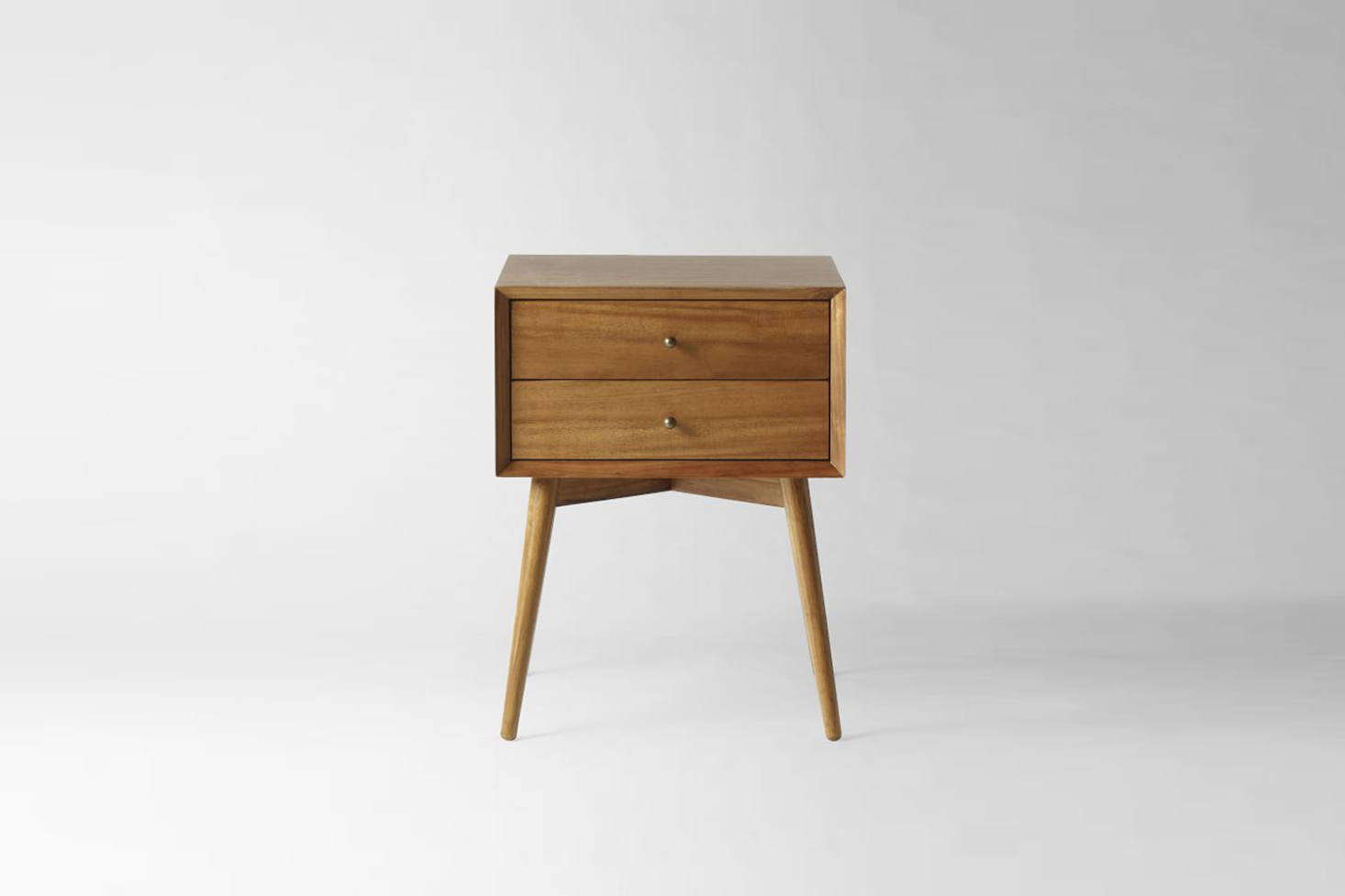 A similar Mid-Century Nightstand in an acorn-colored finish is $9 at West Elm.