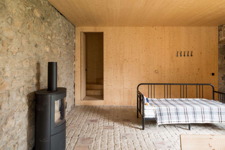 A tartan blanket in a sparsely appointed bedroom in the Cornish countryside; see more in A Former Vicarage Soulfully Updated by Architect Amin Taha. Photograph courtesy of The Modern House.