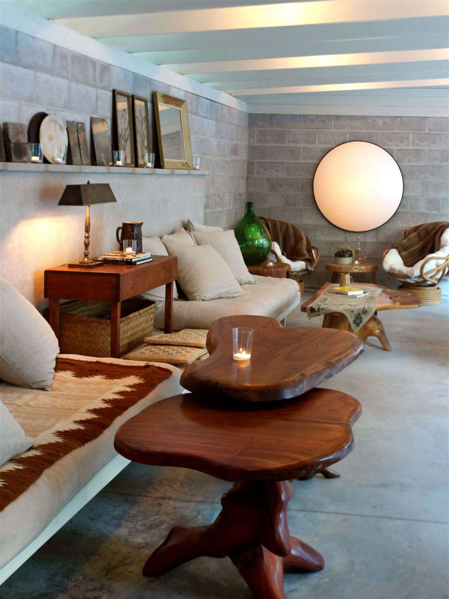 In the adjoining lounge, tree stump tables and masonry walls 