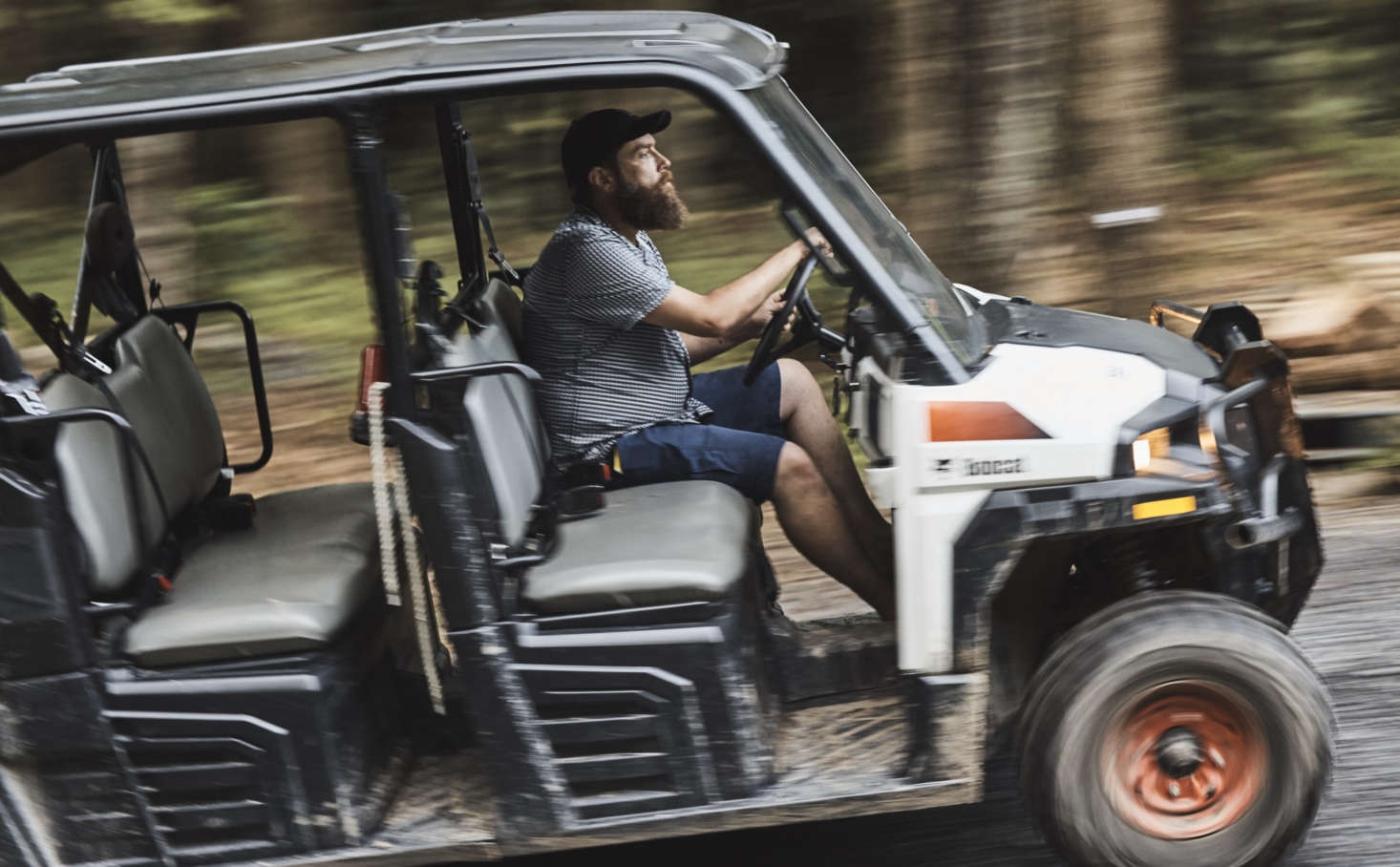 Zak gets around the grounds, and shuttles luggage (and guests on request), in a Bobcat. Photograph by Nick Bean.