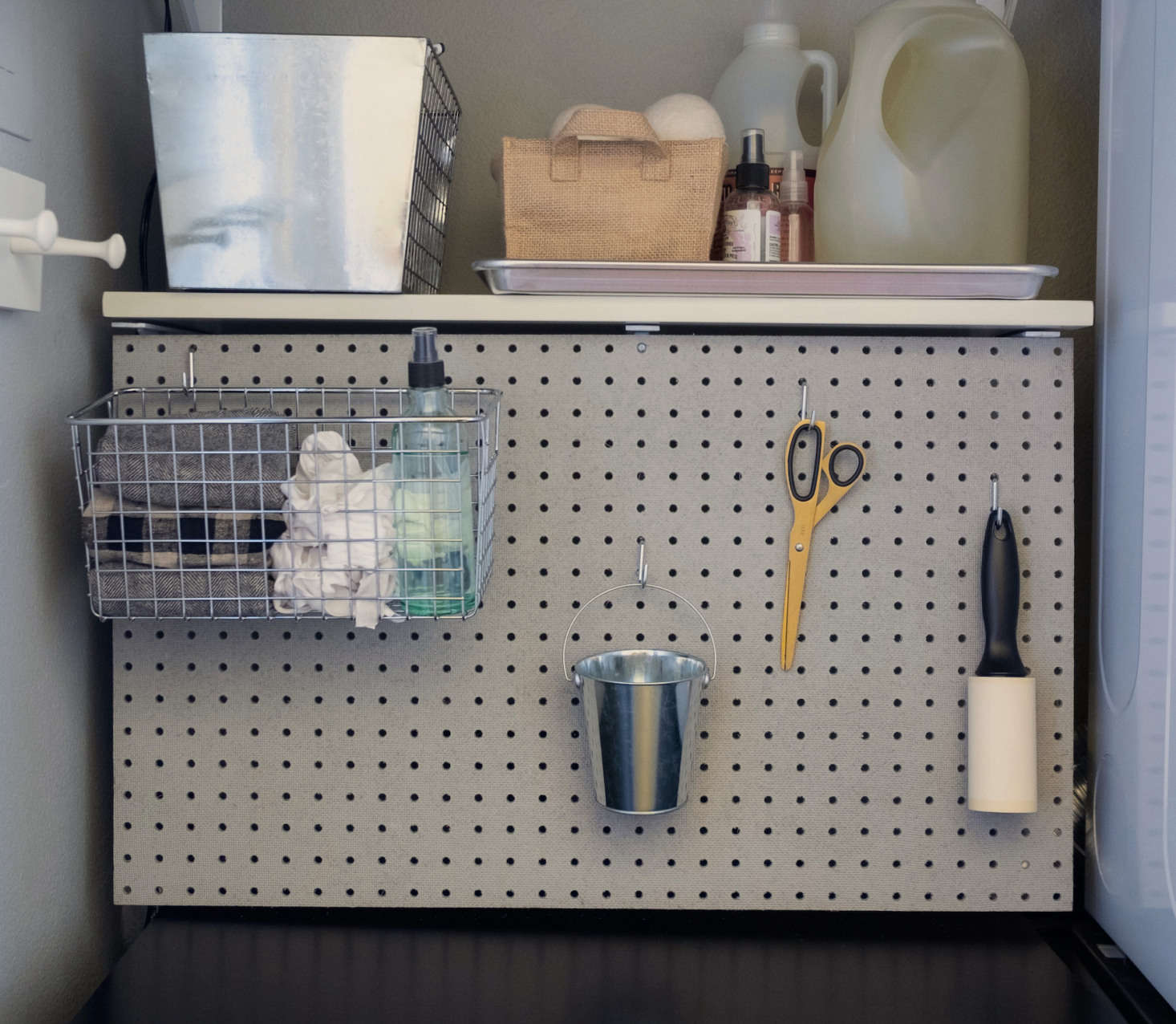 The simplest solution for keeping small items organized and at hand: Pegboard ($9.data-src=
