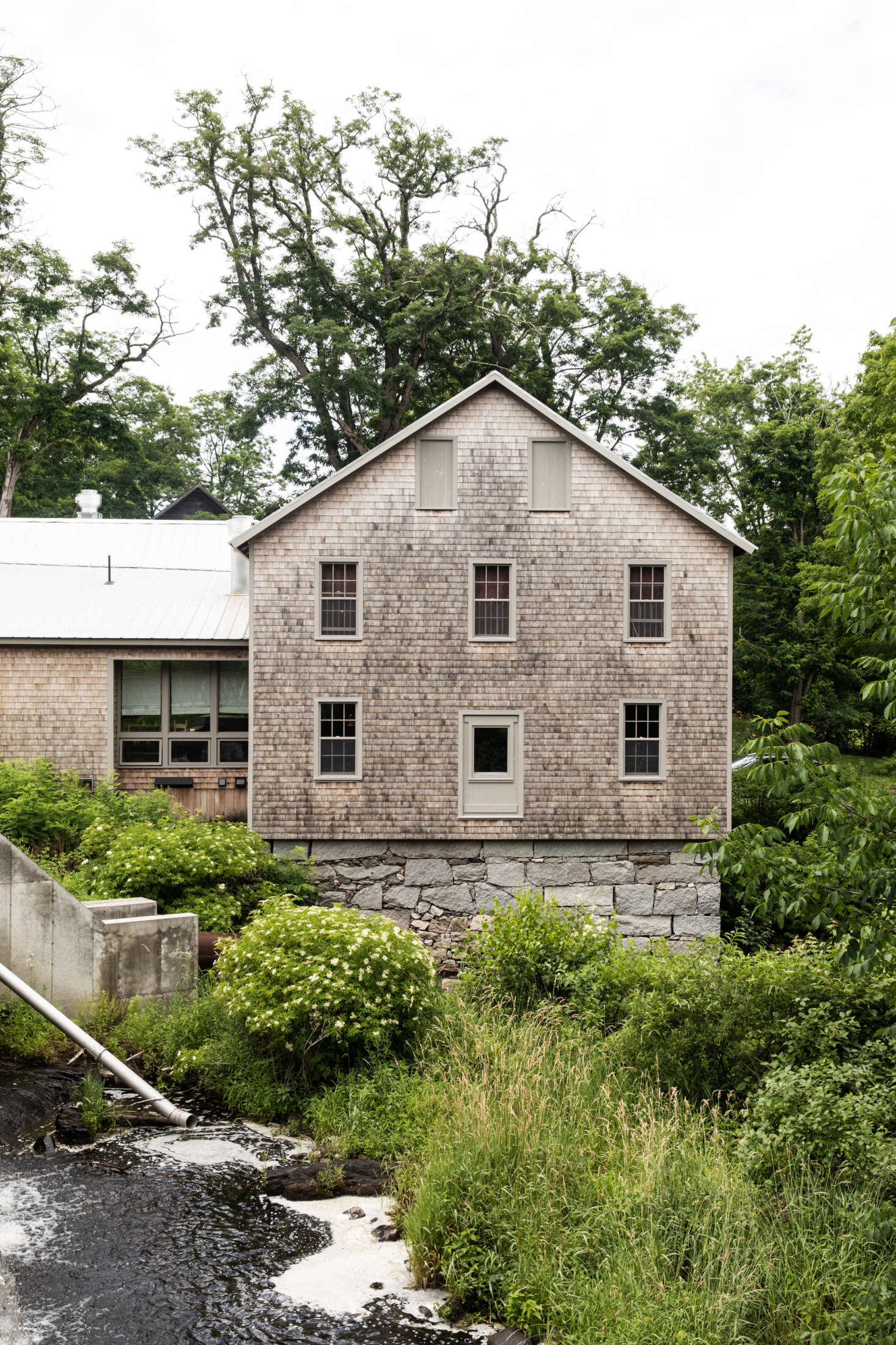 To get to the Lost Kitchen, diners cross a narrow footbridge above the falls.