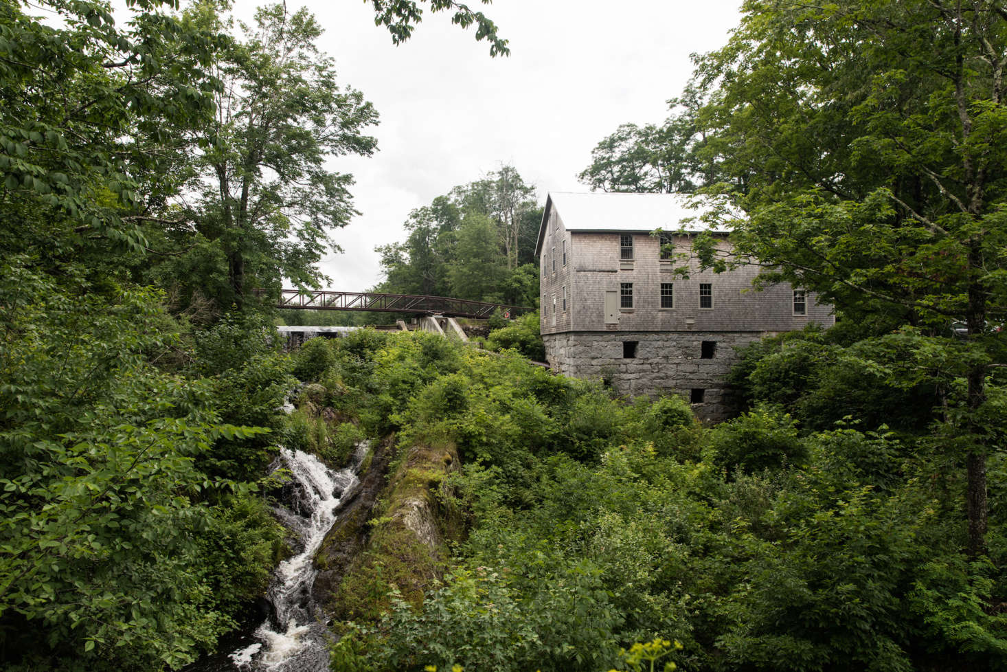 The Mill at Freedom Falls, where the Lost Kitchen is located, is perched above a wide creek. The 34 building was formerly a gristmill, then a turning mill, but had been abandoned for decades and was in danger of falling into the creek before local conservationists and Cold Mountain Builders worked to restore it, shoring up the granite foundation and replacing the timbers.