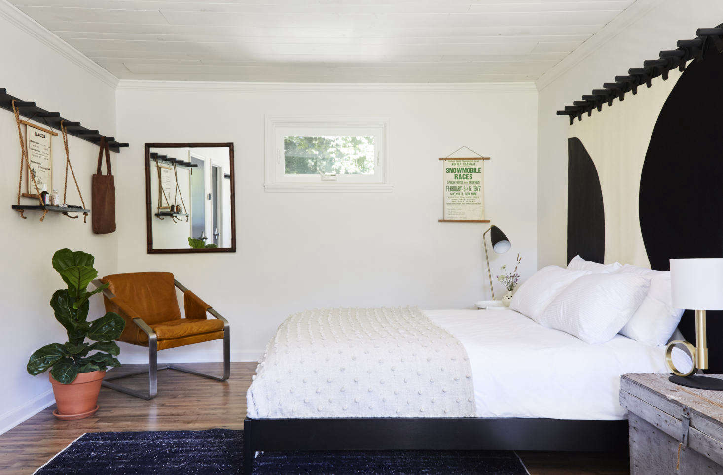 The custom bed curtains are the work of Brooklyn leather studio Moses Nadel; they hang from Pflug