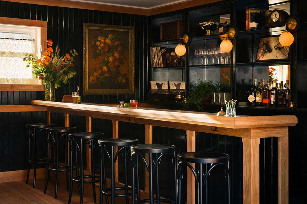 Inside the lobby, dark-painted cladding surrounds the bar for dramatic effect.
