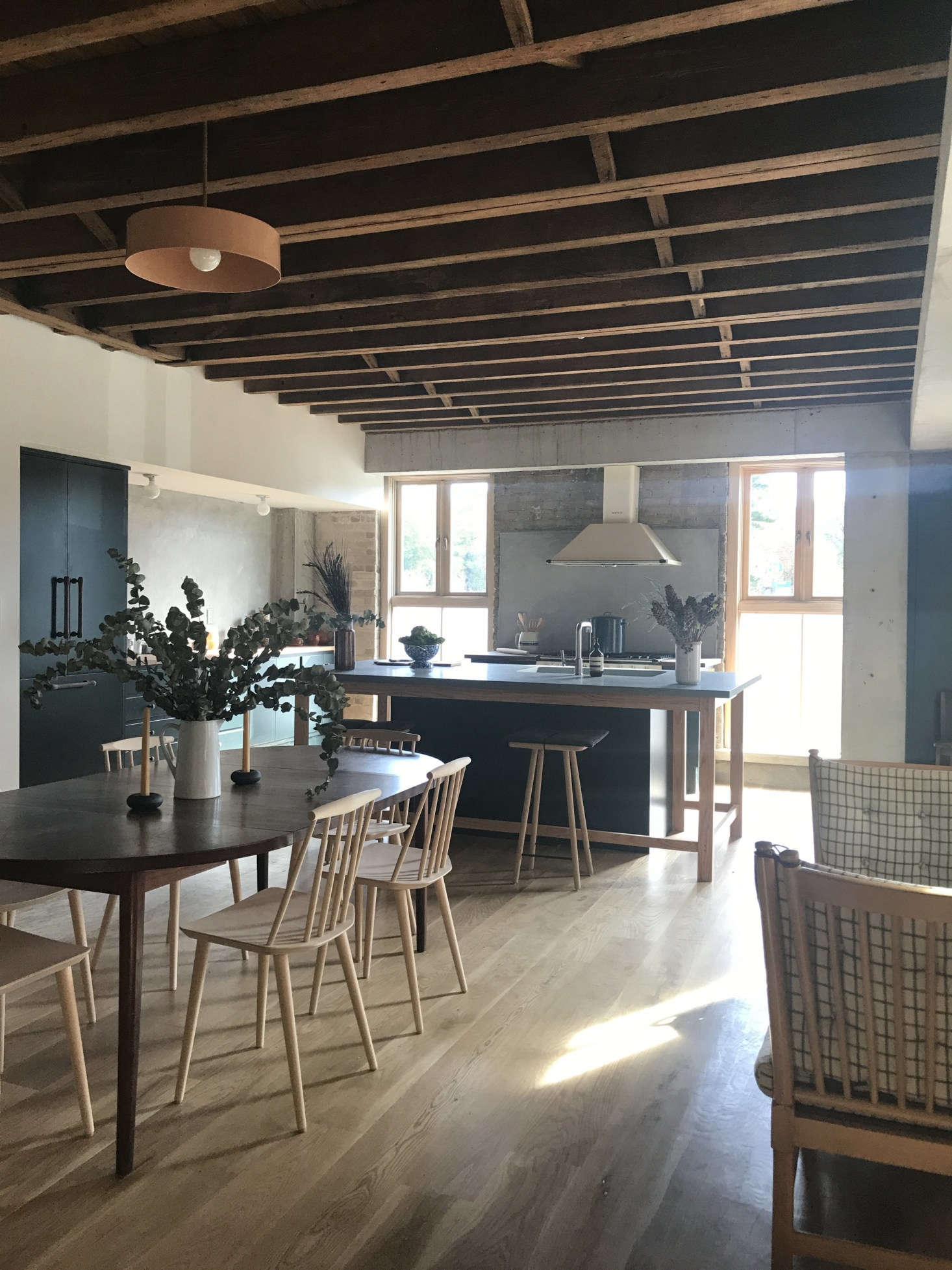 Greenery of all sorts adds life to a room—and it doesn’t need to be real to work its magic. The Hoveys created casual arrangements for the kitchen end of the living space at Fifth & Green.