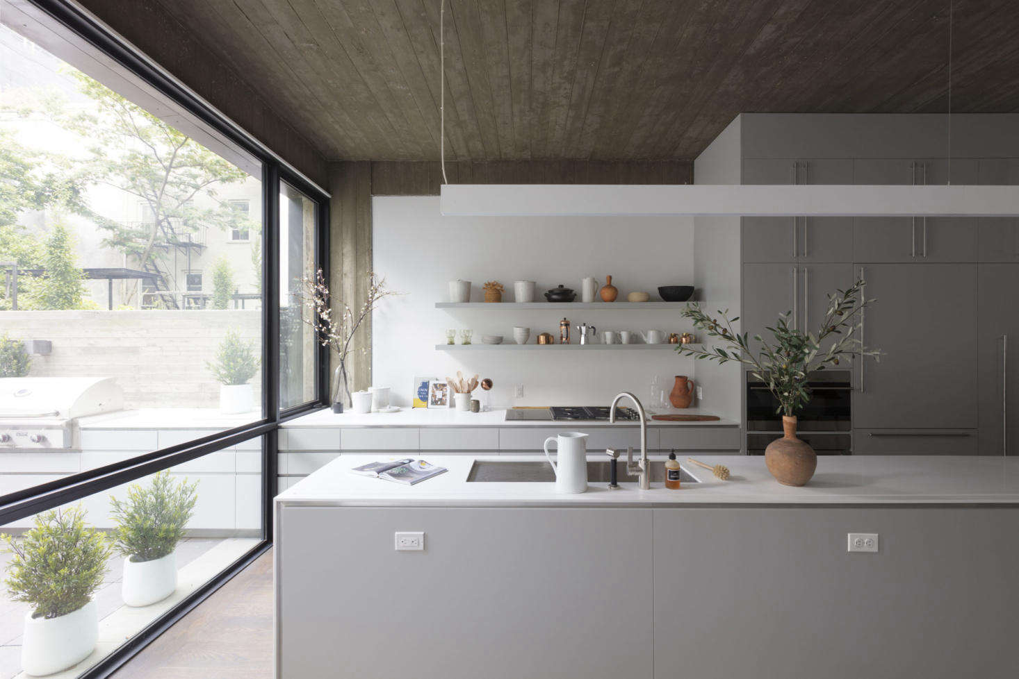 A kitchen styled with ceramics at Wythe Lane, a collection of six new single-family townhouses in Williamsburg developed by KUB and designed by the firm’s in-house team in collaboration with SZ Projects.