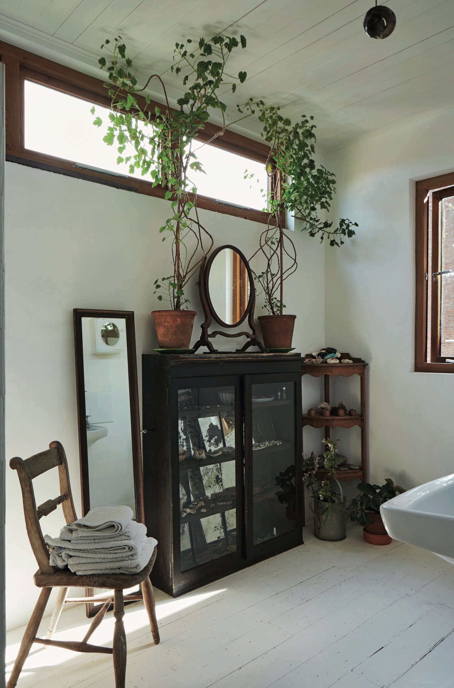 Still a work in progress, the master bath has new windows and is completely painted white.