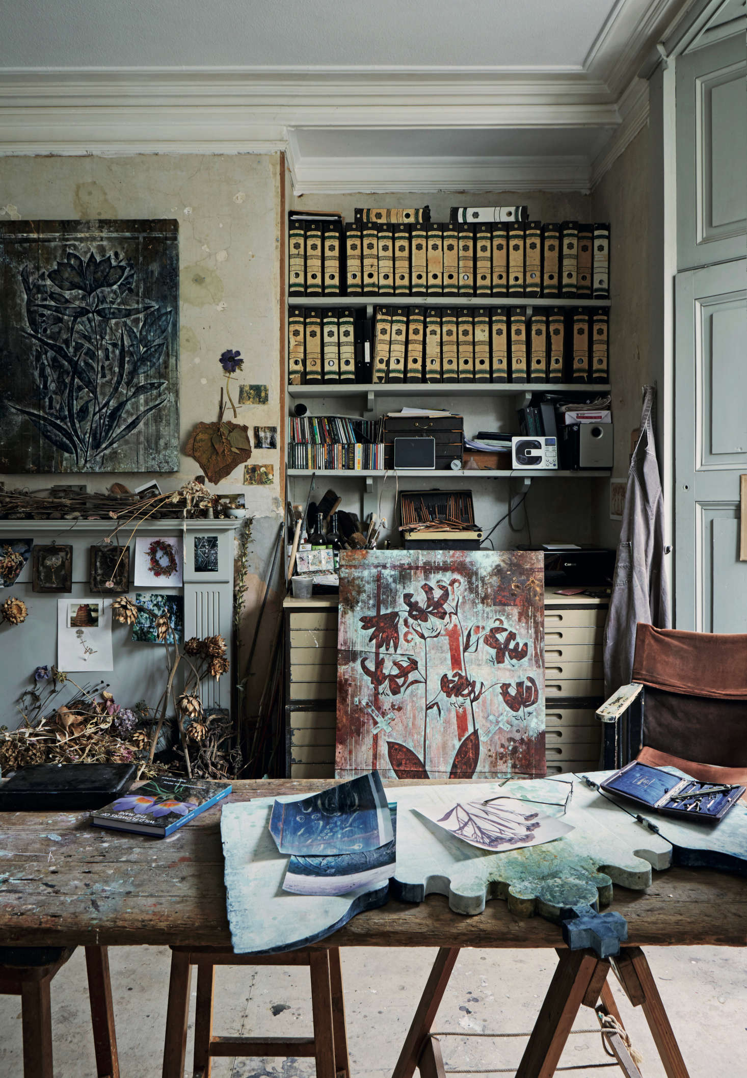 There are countless places for the eye to land in David’s studio. The mantel is layered with dried leaves and stems, and the top drawers of his flat file are divided into compartments for his Thames mudlarking finds, sorted by color: white clay pipes, shells, and bleached bones; clear glass bottles; and iron relics, among other things.