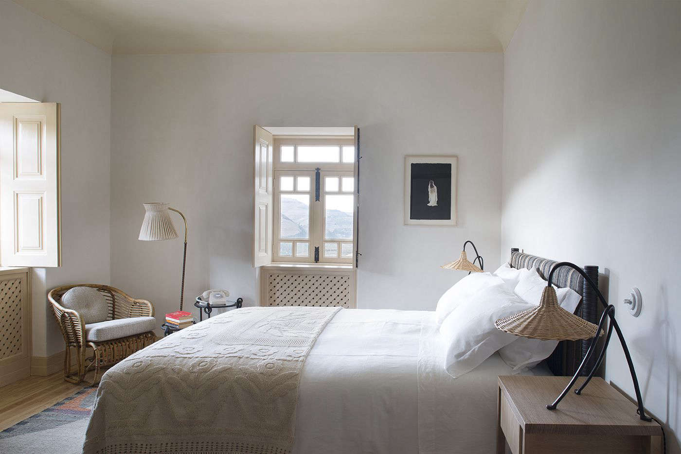 Each bedroom is fitted with rattan lamps, mix-and-match patterned blankets, and a rotary phone, an indication of the property’s low-fi, off-the-grid ethos.