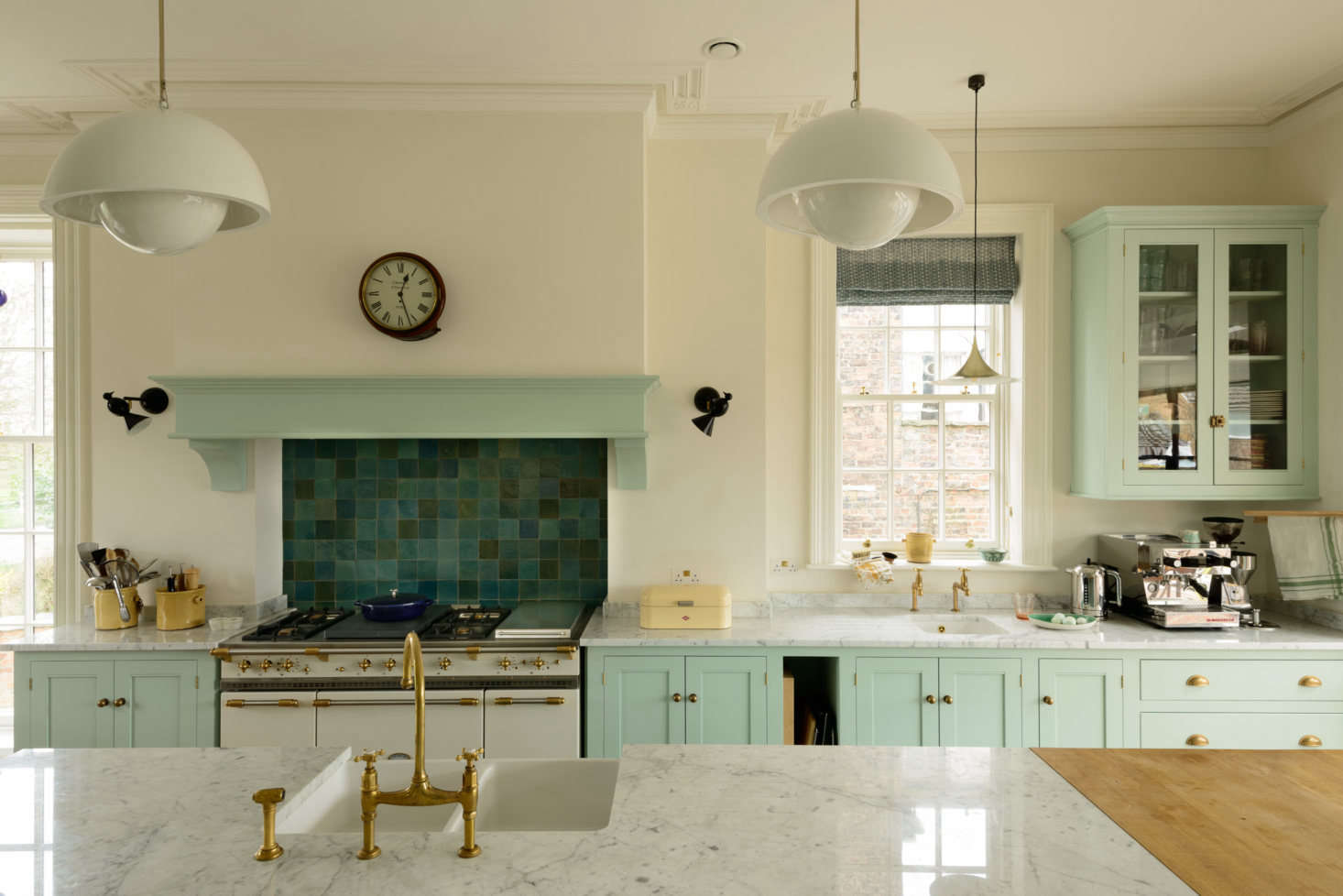 The Lacanche range, the 150 cm Citeaux, was slotted into an old chimney breast. It sat in its crate in the middle of the unfinished room for months while walls were plastered and windows fitted. It was a splurge, but it‘s a beauty and we plan to have it forever (it stopped working during its inaugural run last Thanksgiving, when the turkey was in the oven, but has since been all I had hoped.) The island’s brass bridge faucet, the Aged Brass Ionian Tap, is from deVol. The black bird sconces are the Alouette Wall Lamp by Atelier Areti.