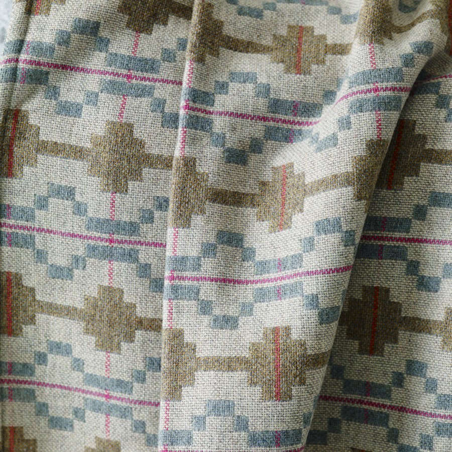 A detail of the blue and olive green woven Kinmel Blanket from Rowen & Wren. They also carry the Towyn Striped Blanket from Melin Tregwynt; £data-src=