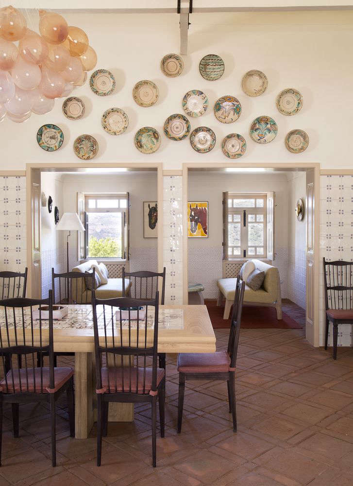 The table in the dining area is inspired by one the architect remembers from his childhood, in his family’s Alpine chalet; this recreation features tiles hand-painted with a map of the Douro Valley. The diamond pattern on the floor is hand-drawn and slightly imperfect.