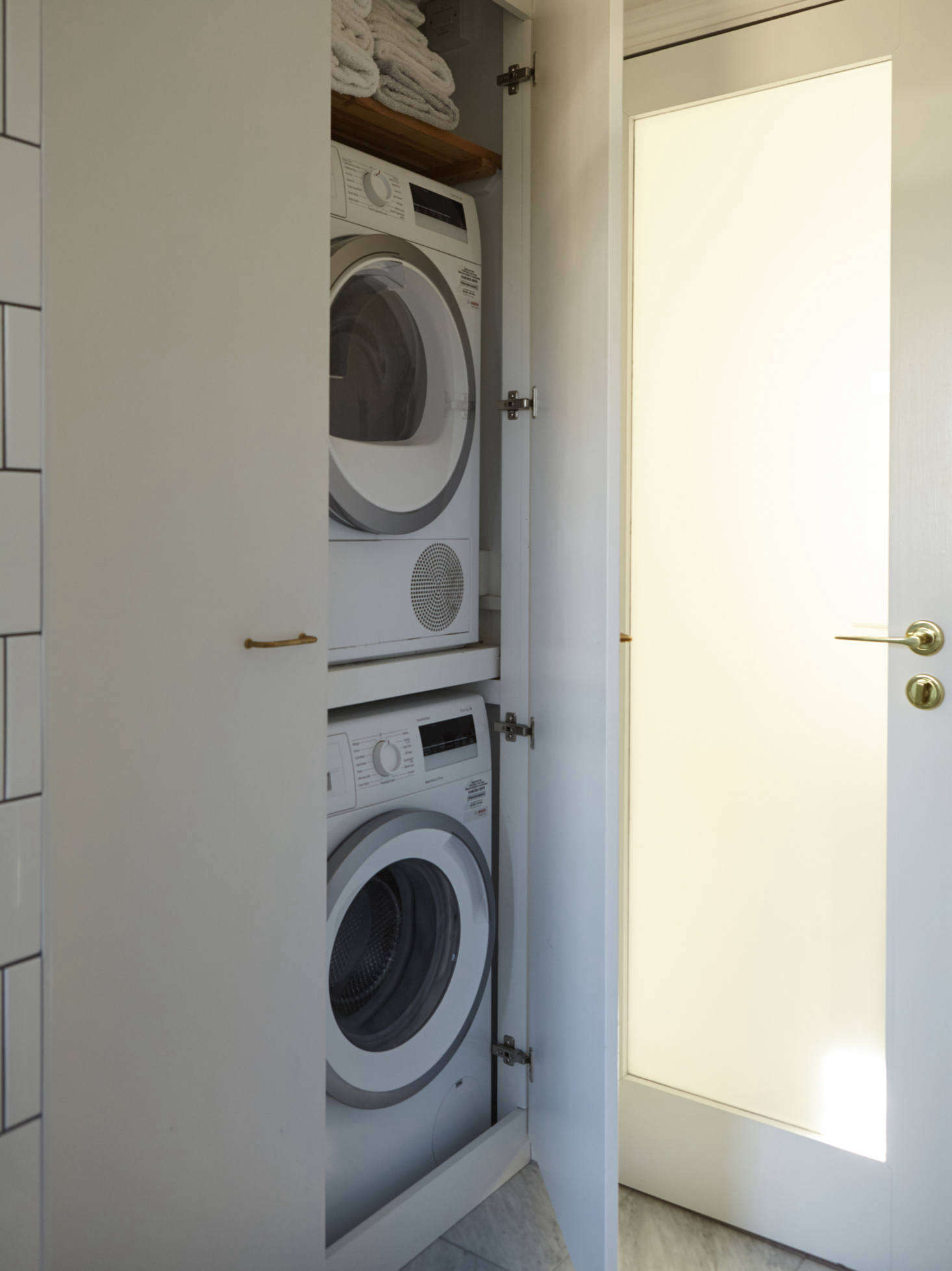 Compact London living means integrating the washer/dryer into the bath as well. Photograph by Richard Round-Turner from A Star Is Born: A Rehabbed London Maisonette from a Newly Minted Designer, High/Low Secrets Included.