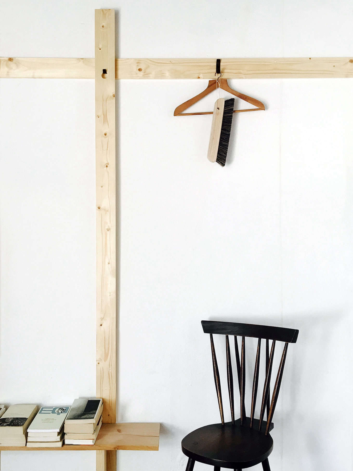 Removable black hooks turn the simple lengths of wood into storage.