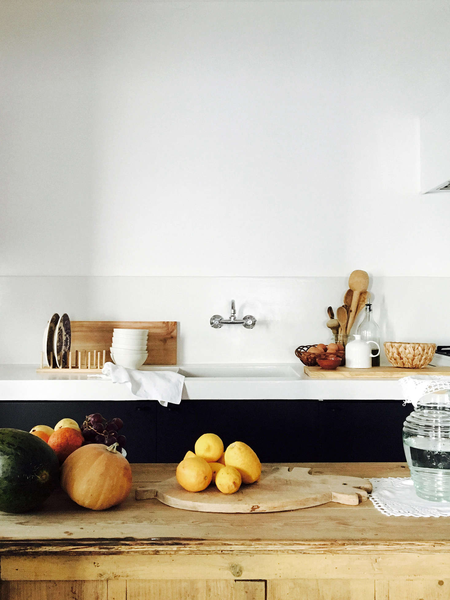 The kitchen, with poured-in-place concrete countertops and backsplash (“single pour,” Bento says) and a rough-hewn wooden island.
