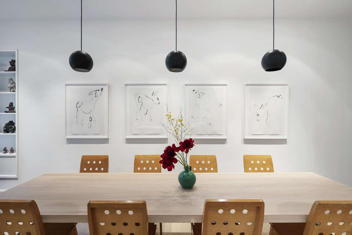 O’Neill’s firm oversaw the architectural elements and the hardware, but Sam and his partner decorated the home themselves with vintage finds and modern art. The quartet of drawings is by Sam’s father. The vintage dining chairs were designed by Roland Rainer for the Vienna City Hall.