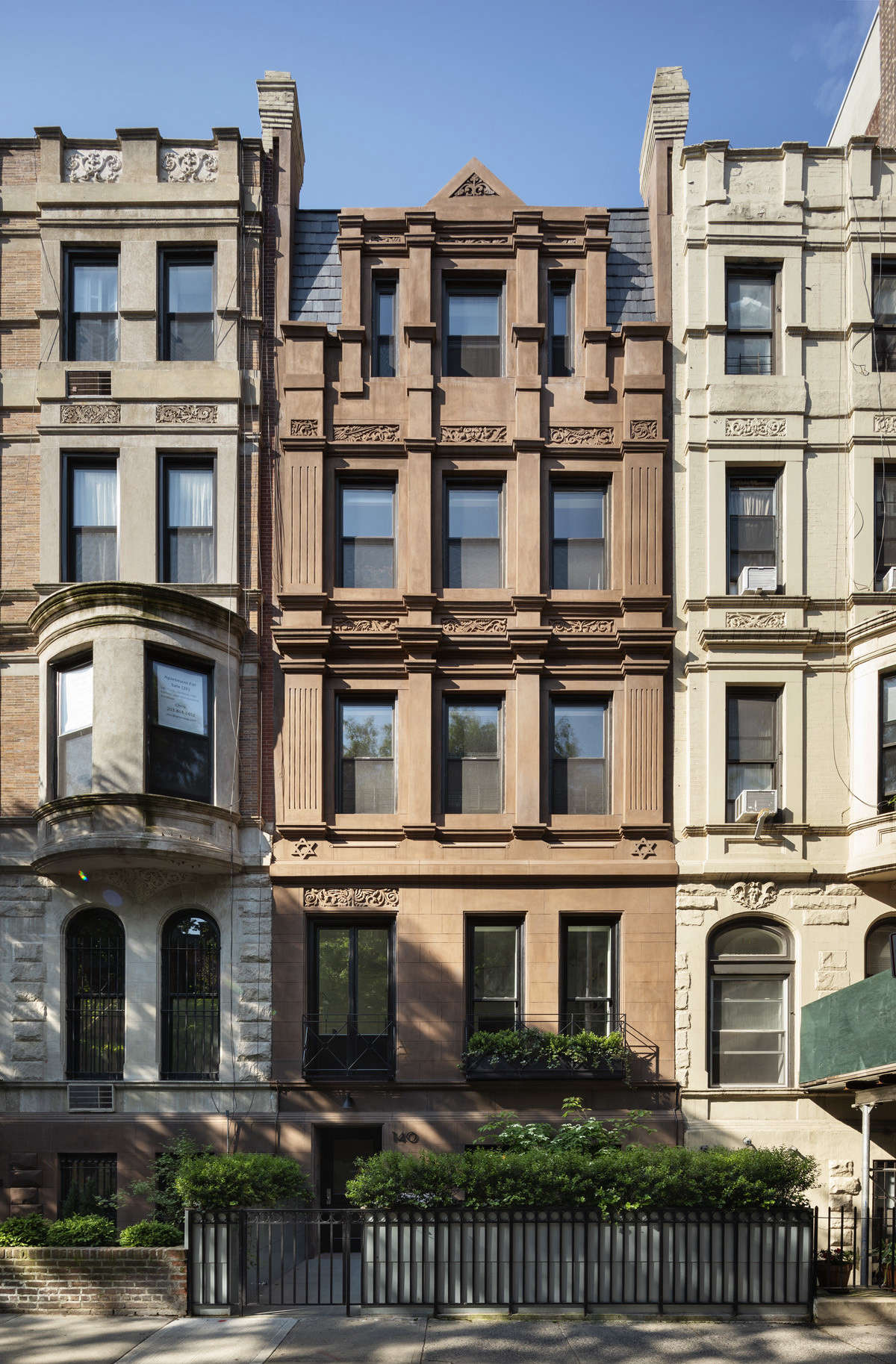 The rehabbed front exterior. Note the Jewish stars, vestiges from the building’s former life, just above the second floor.