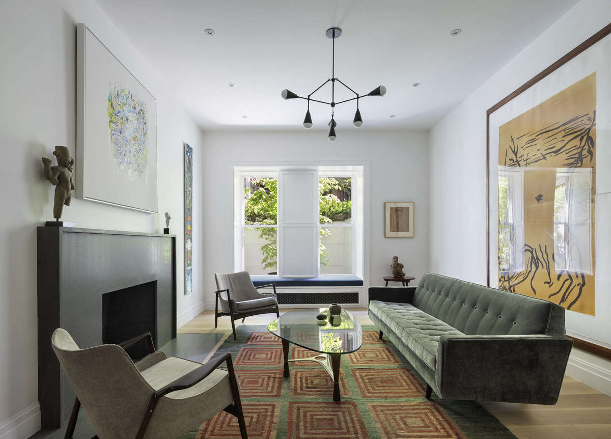 Art plays a central role in the home, both past and present. Above the living room fireplace is a work by Robert Harms; to the right is a Malcolm Morley painting; behind the sofa is a Julian Schnabel; and next to the window is a piece by Jean Dubuffet.