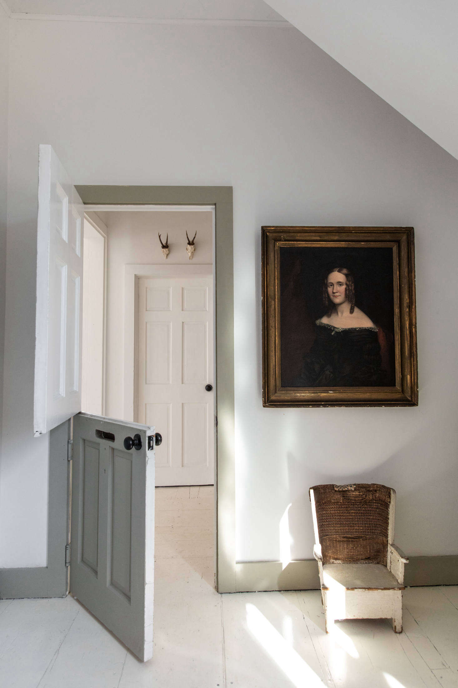 Just off of the entryway, a Dutch door leads to a small bedroom, the first of four.