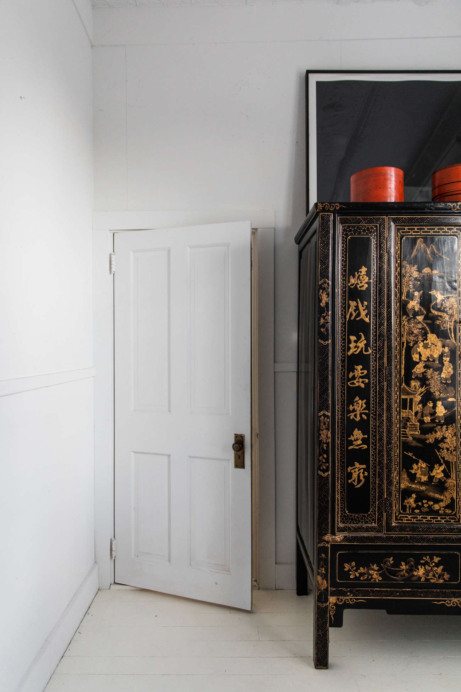 At the foot of the bed is a black lacquer Chinese armoire that McNeil found in Lincolnville. 