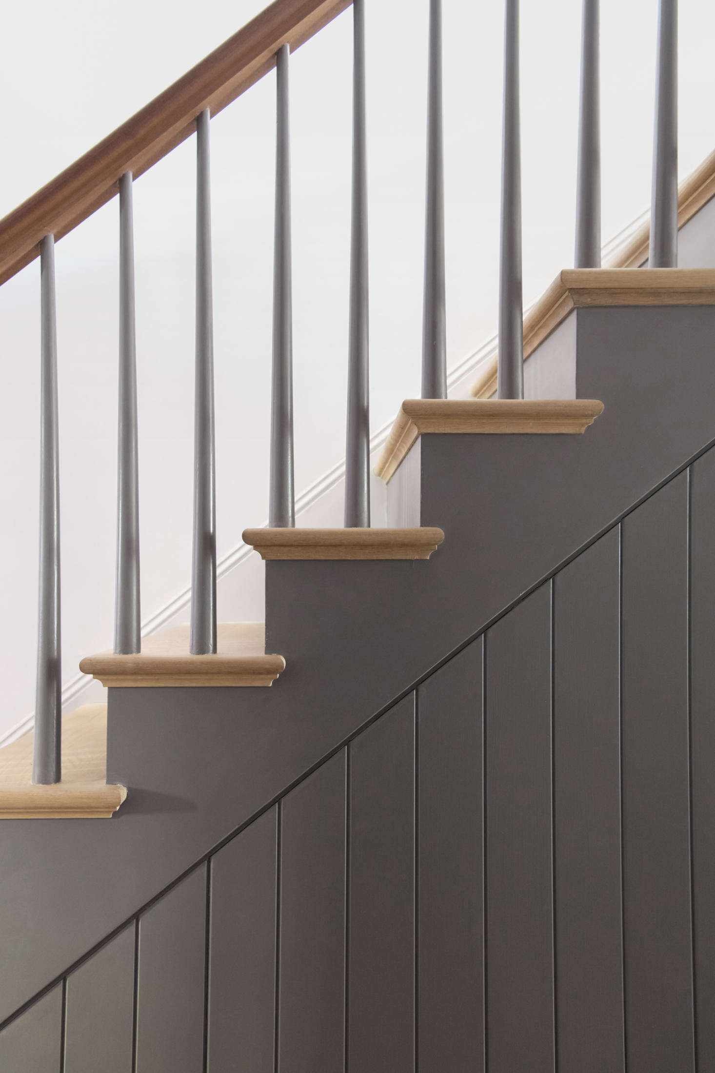 “The original stair on this level was long gone, so we created a design that felt right,” Lekwa tells us. “The treads are white oak, the handrail is mahogany to match the original on the upper floors, and Elizabeth Roberts designed the custom beadboard paneling.”