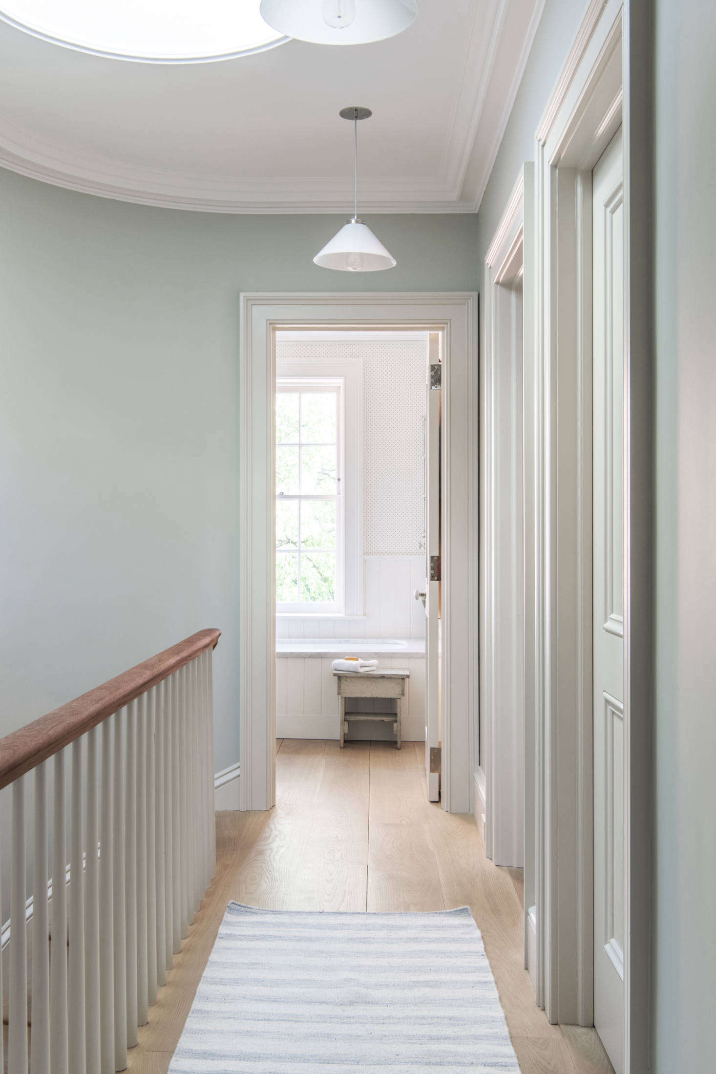 The skylit top floor is the children’s quarters. The mahogany handrail is original and the rest is a replica. The walls are painted Cromarty and the trim is Shadow White, both from Farrow & Ball.