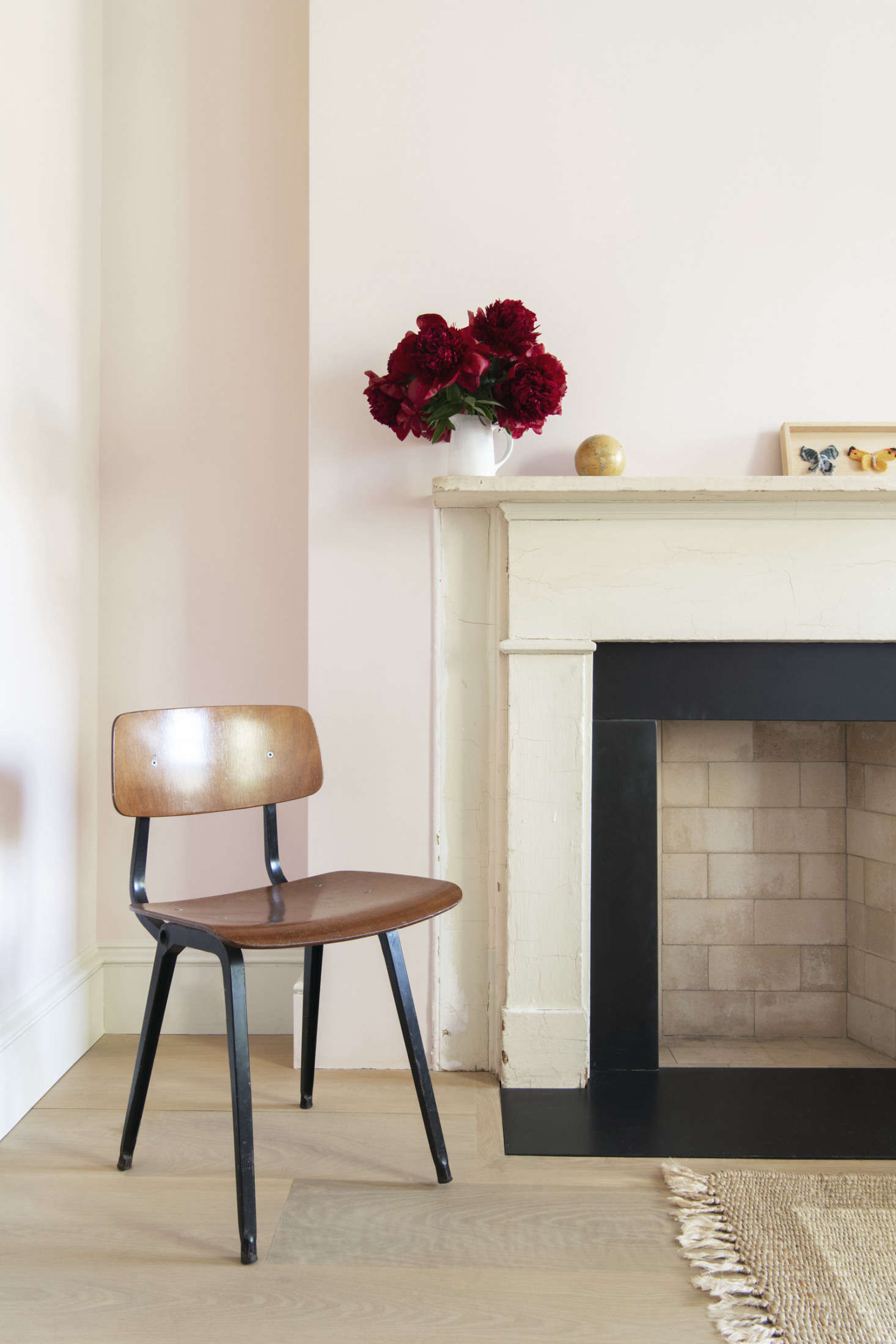 The house’s only original, untouched detail is this wooden bedroom mantel: “Our client wanted to leave something that was old and not fixed up,” says Lekha. (It, nonetheless, has a new Italian slate surround selected for its matte finish.) The vintage steel and wood Result Chair is a 1950s Dutch design currently being reproduced by Hay.