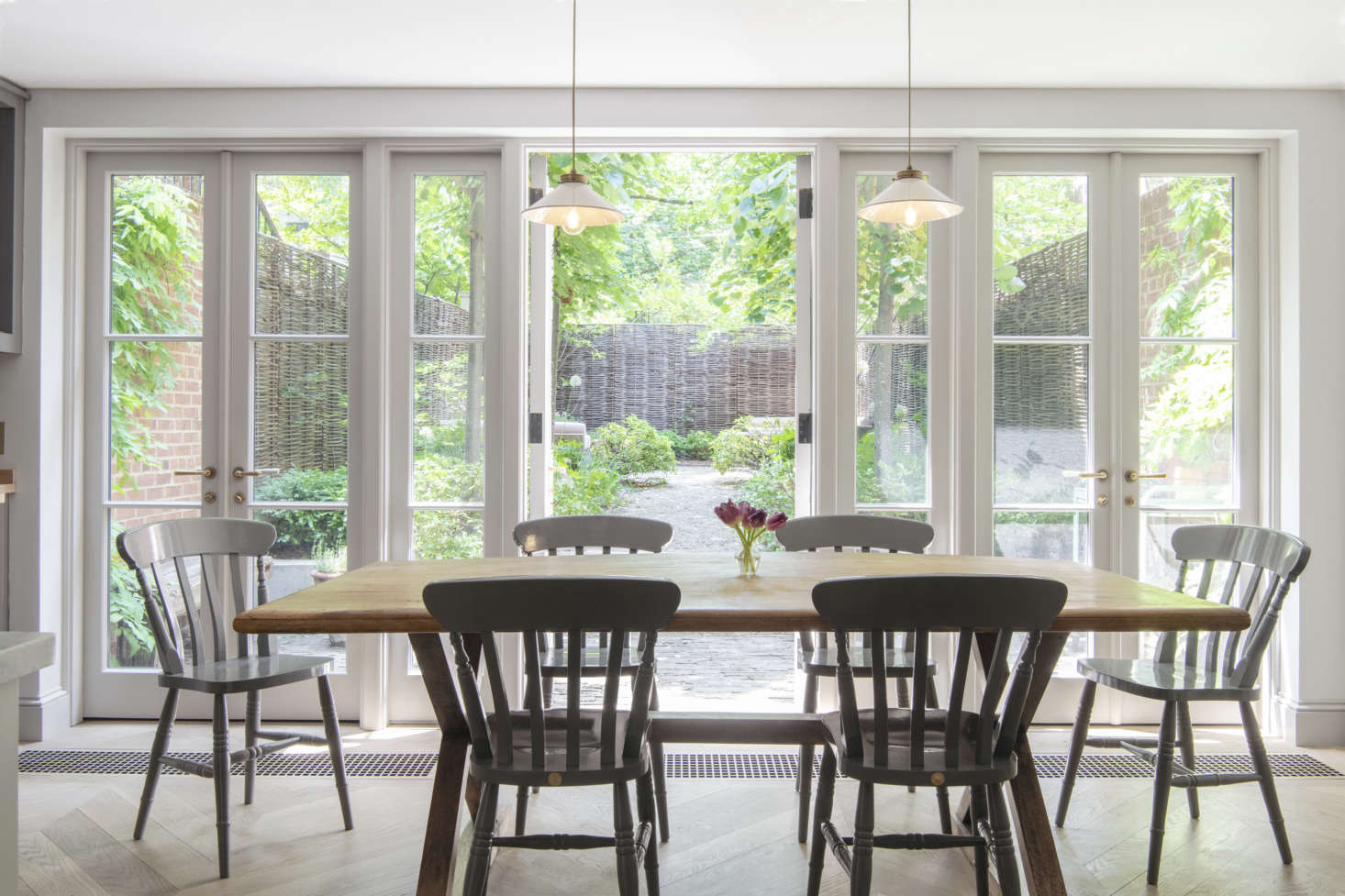 The owners decided to keep the kitchen in its original location because they like the link to the garden—”when we lived on the upper stories of a townhouse, we almost never used the stairs to the garden”—and wanted a big living room on the parlor floor. The eating area is set in the extension, which is the width of the house and 10 feet deep.
