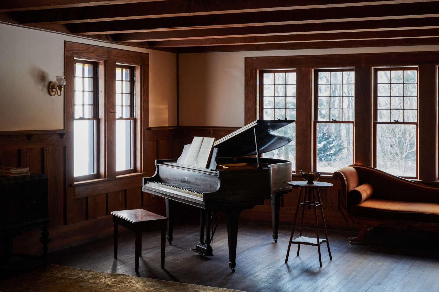 A baby grand piano anchors a corner of the ballroom, where the children of the house host impromptu dance parties. 