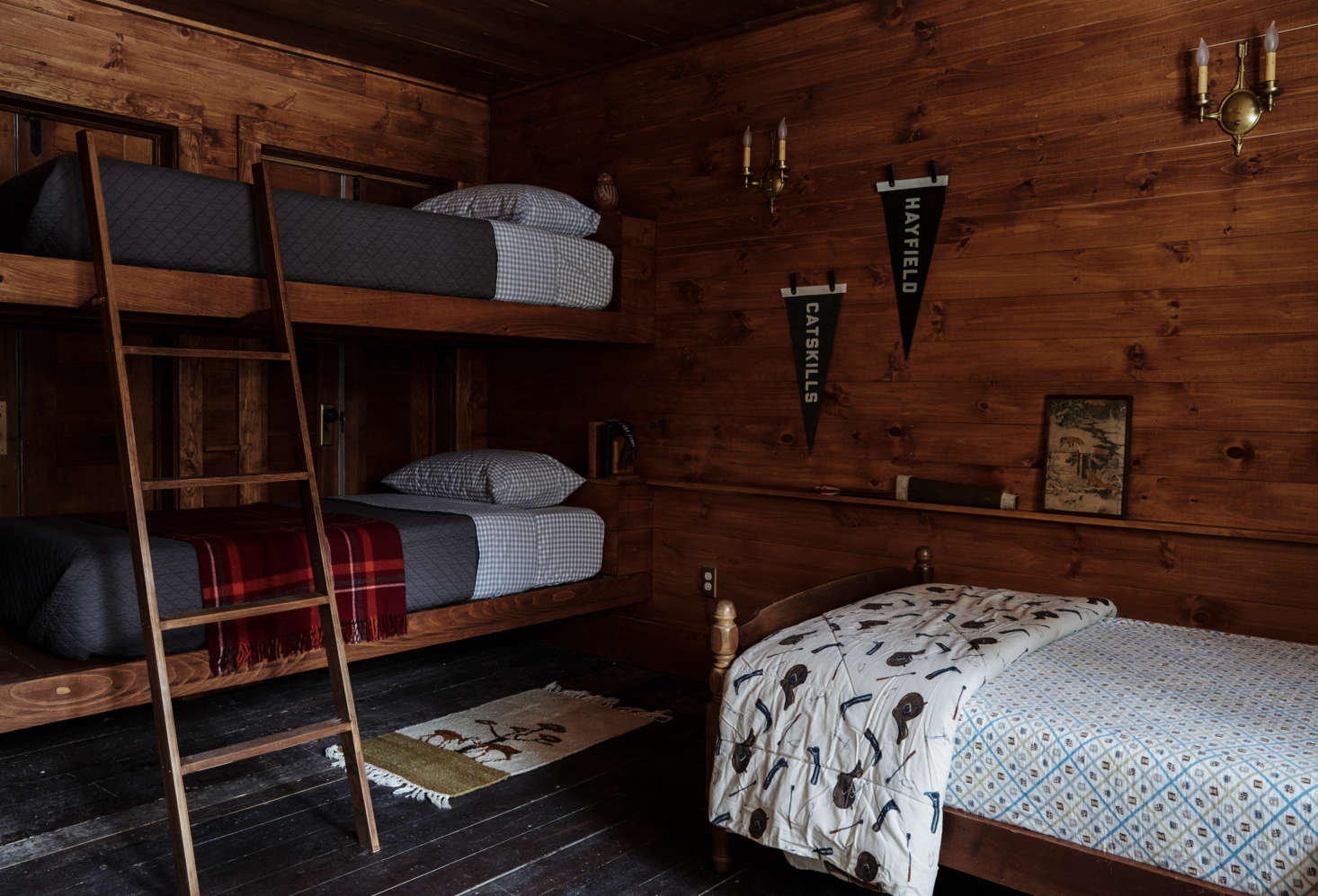 The newly paneled bunk room features custom beds by Percy.