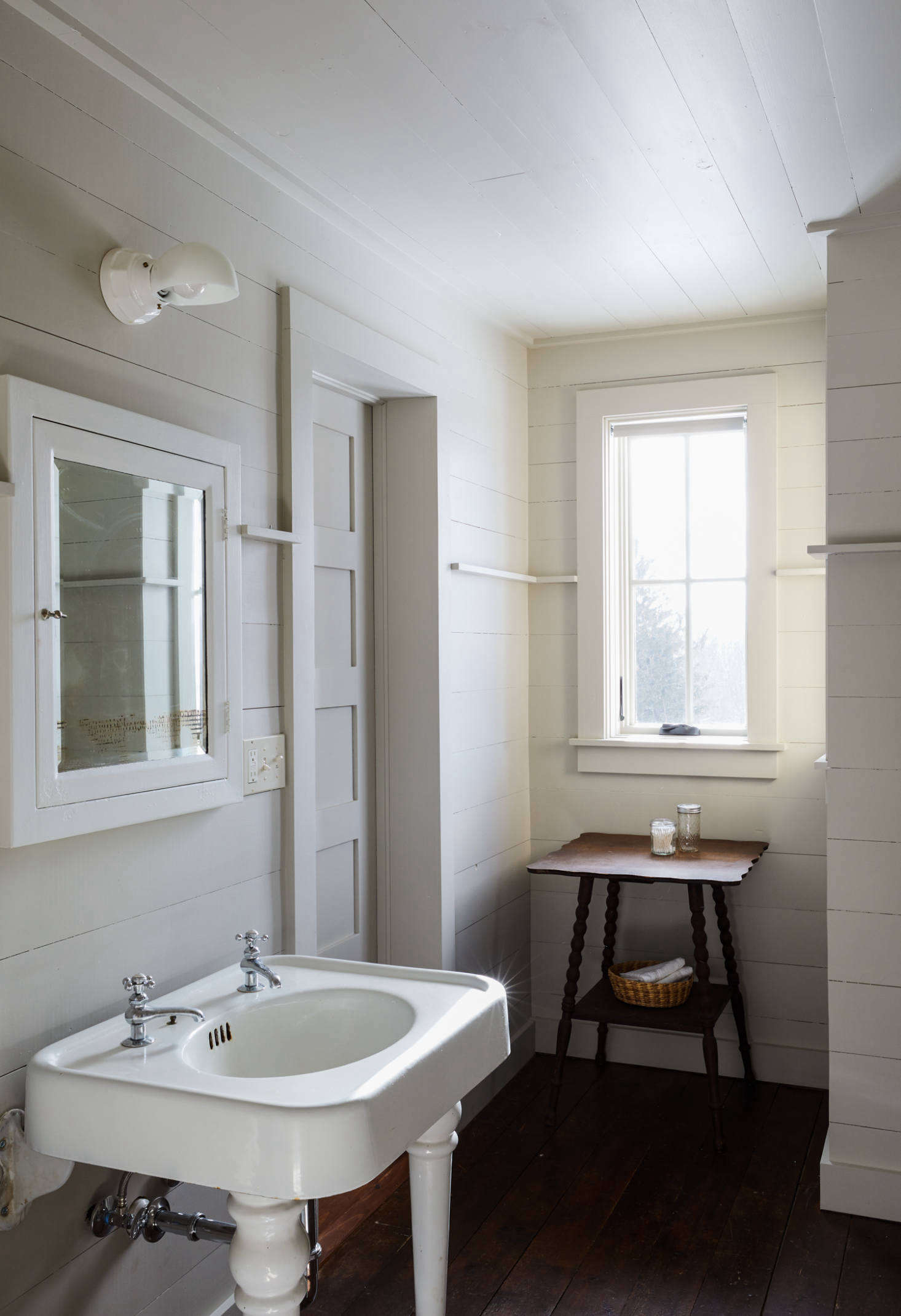 Tara and Percy applied more floor-to-ceiling paneling, painted in Revere Pewter, to the guest room bath.