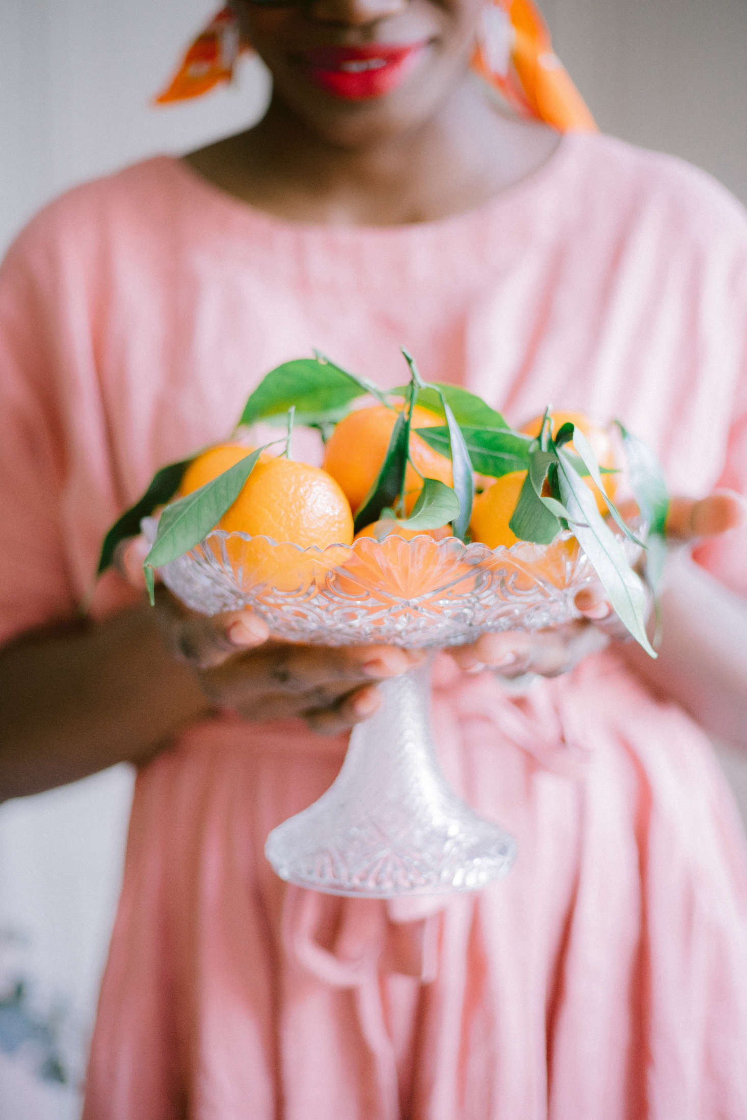 Aki fills a vintage cut-crystal bowl with clementines.