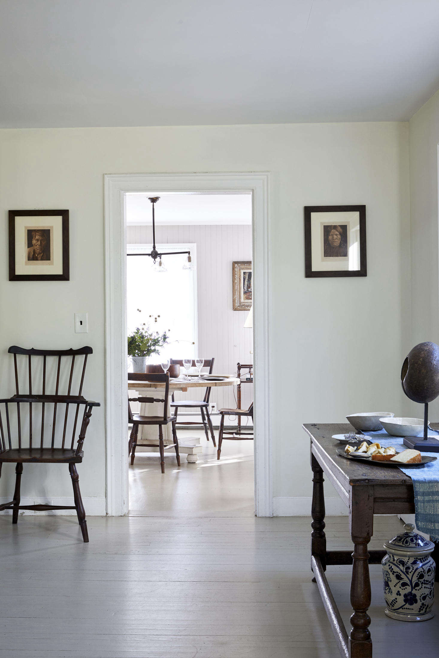 Edward Curtis portraits flank the passage between the living and dining rooms.