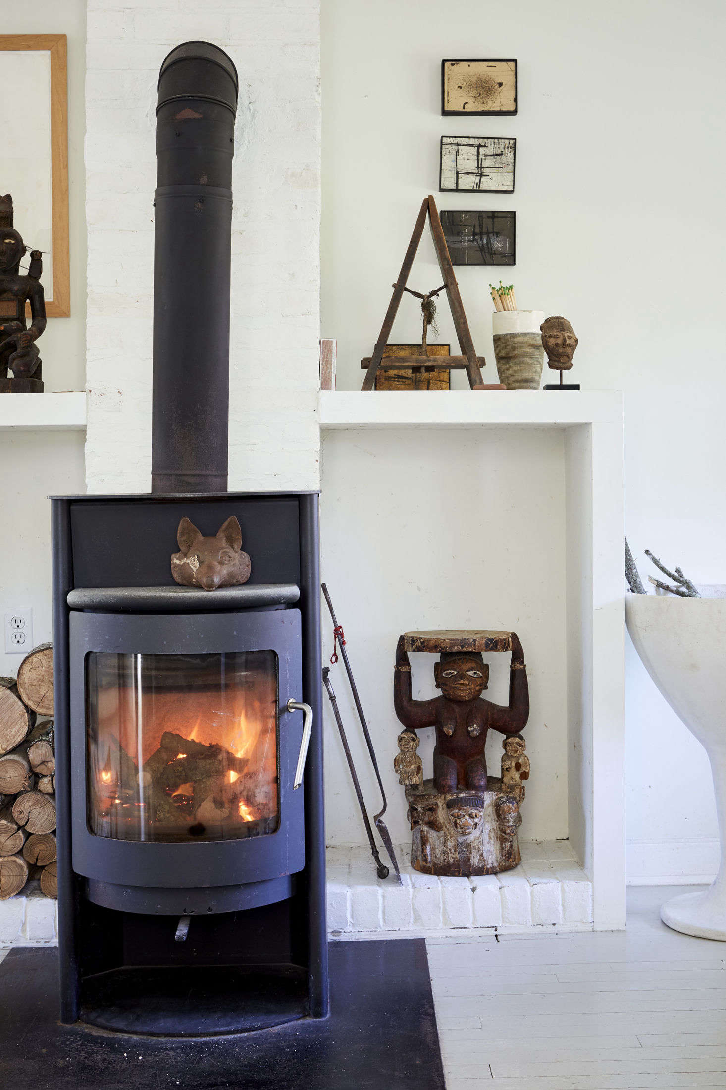 Jonathan added cube-shaped log holders on either side of the stove: 